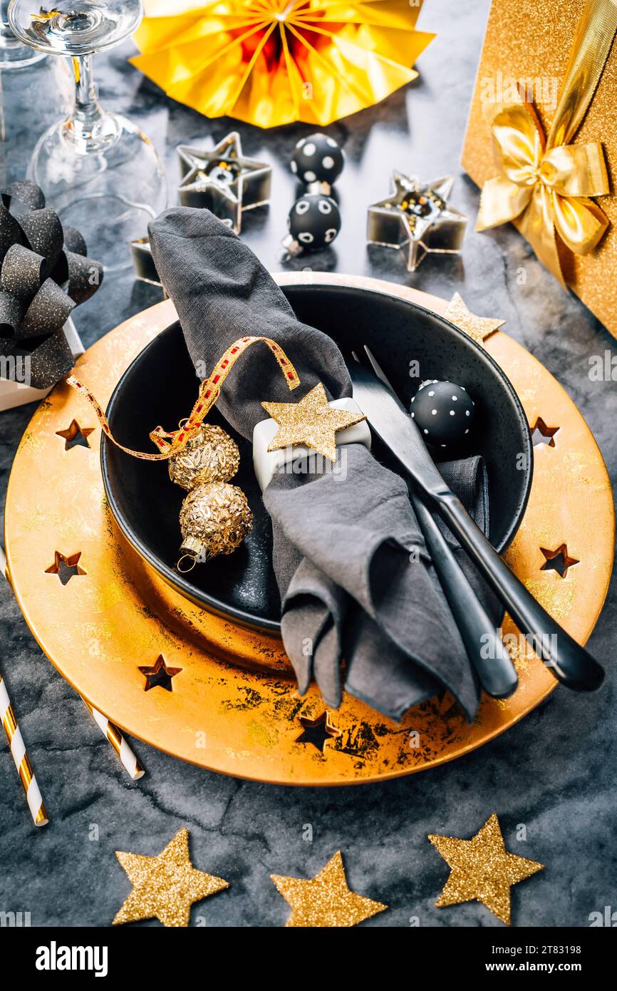 Place setting in golden and black tone for Christmas, New Year Stock Photo