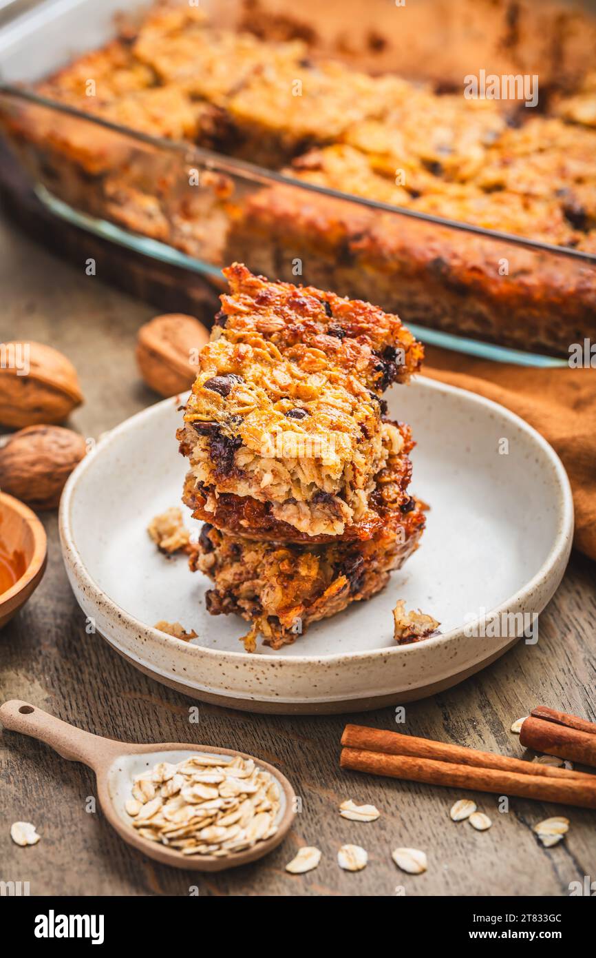 Vegan oatmeal banana bread or case with nuts on wooden kitchen table Stock Photo