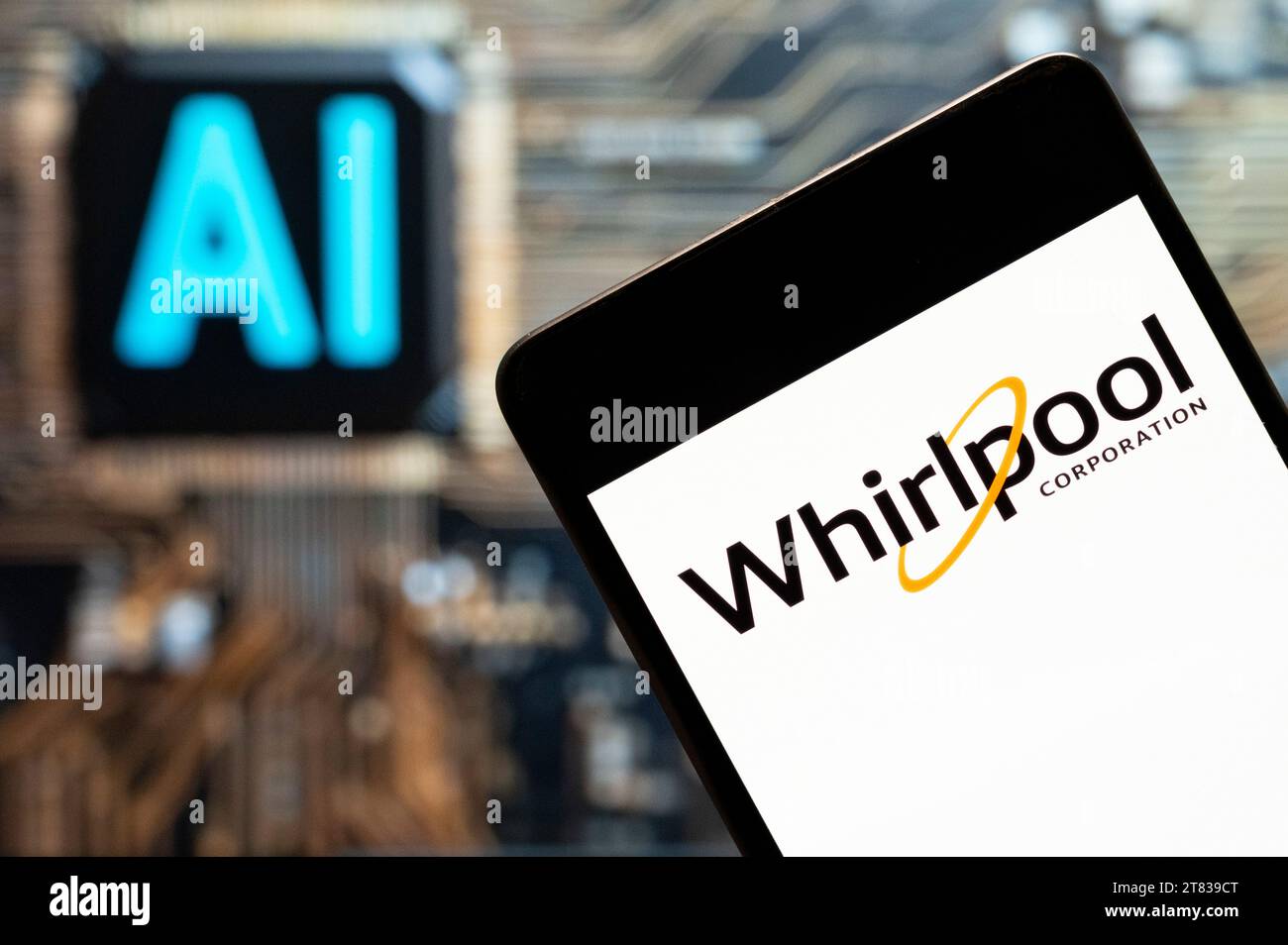 In this photo illustration, the American multinational manufacturer and marketer of home appliances, Whirlpool Corporation (NYSE: WHR), logo seen displayed on a smartphone with an Artificial intelligence (AI) chip and symbol in the background. (Photo by Budrul Chukrut / SOPA Images/Sipa USA) *** Strictly for editorial news purposes only *** Stock Photo