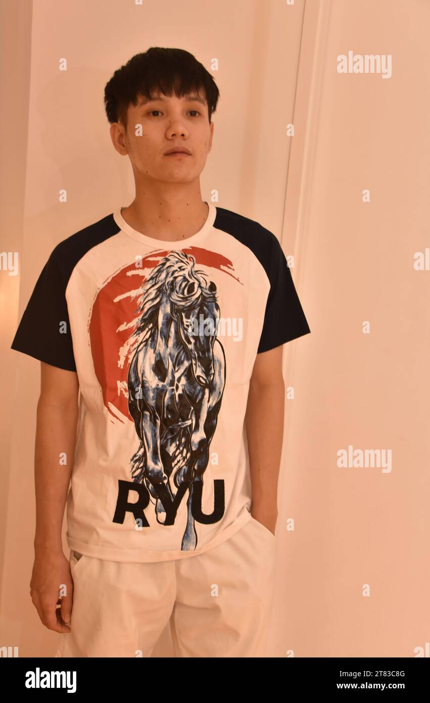 A handsome young, well dressed teenage, Asian boy or man, aged 18 to 24 ...