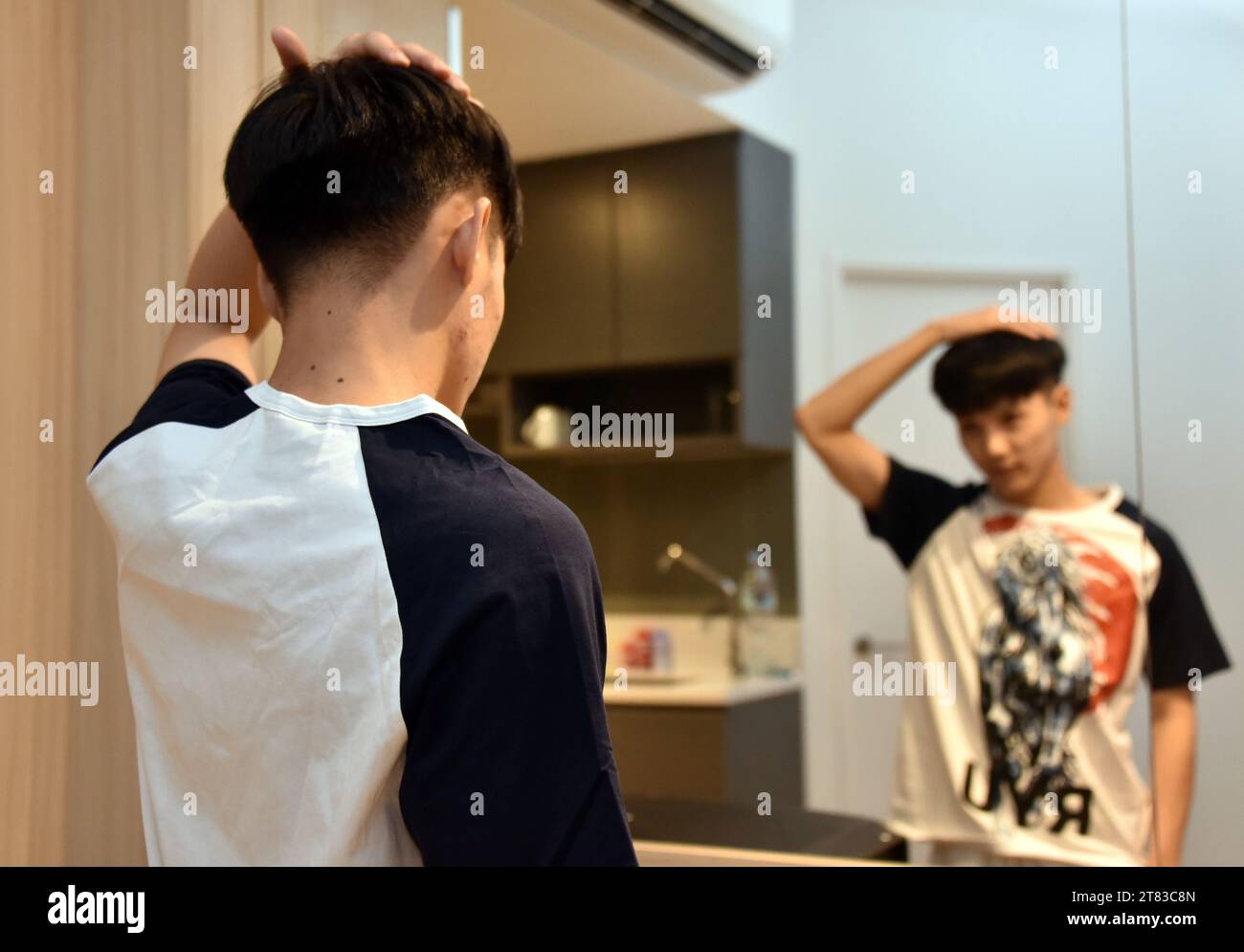 A handsome young, well dressed teenage, Asian boy or man, aged 18 to 24 ...