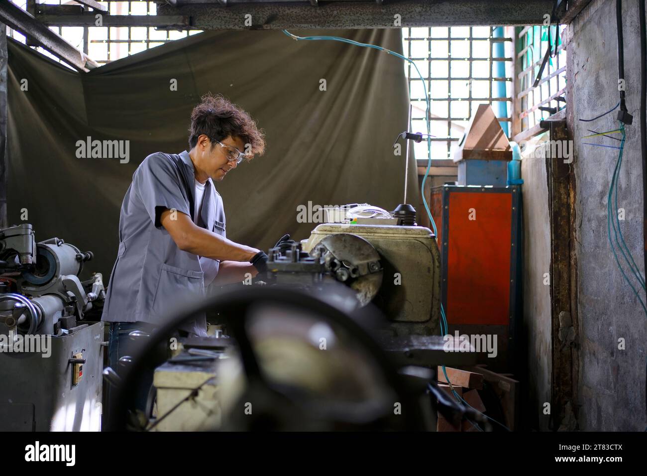 Machine Shop Apprentice Trainee works at machine shop. Metalwork and education concept Stock ...