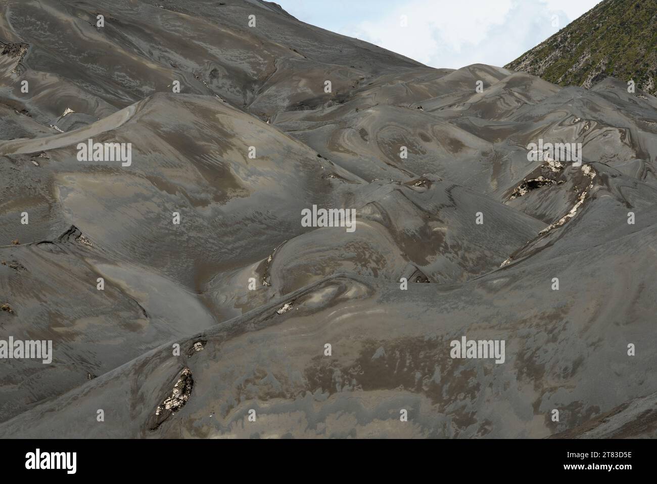 The intricate patterns of a volcanic landscape present a natural tapestry sculpted by geological forces over time Stock Photo