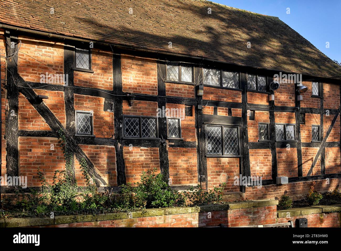 Half timbered red brick listed property with leaded windows. Stratford upon Avon Warwickshire England UK Stock Photo