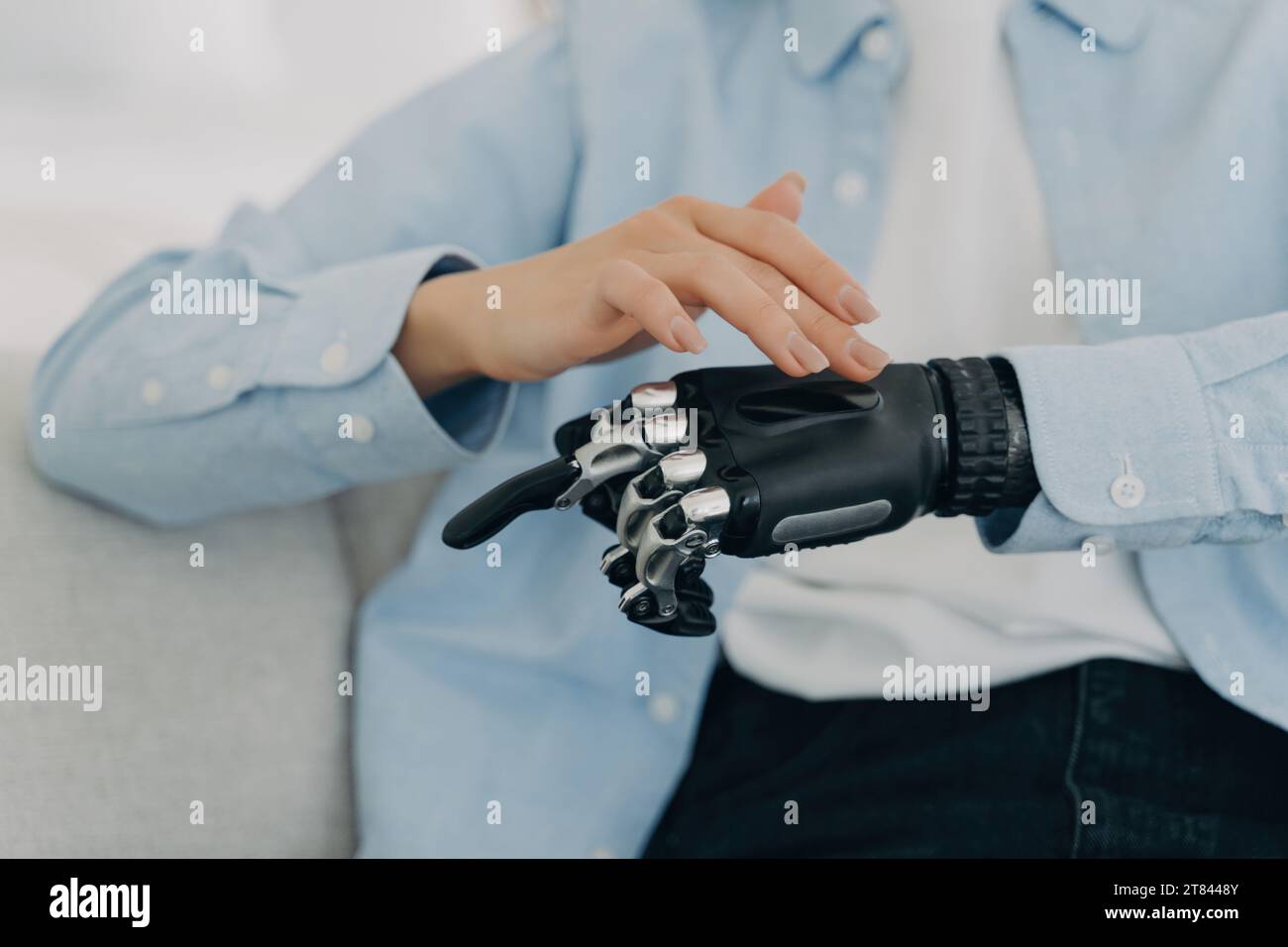 Human touch meets technological innovation with a robotic prosthetic hand Stock Photo