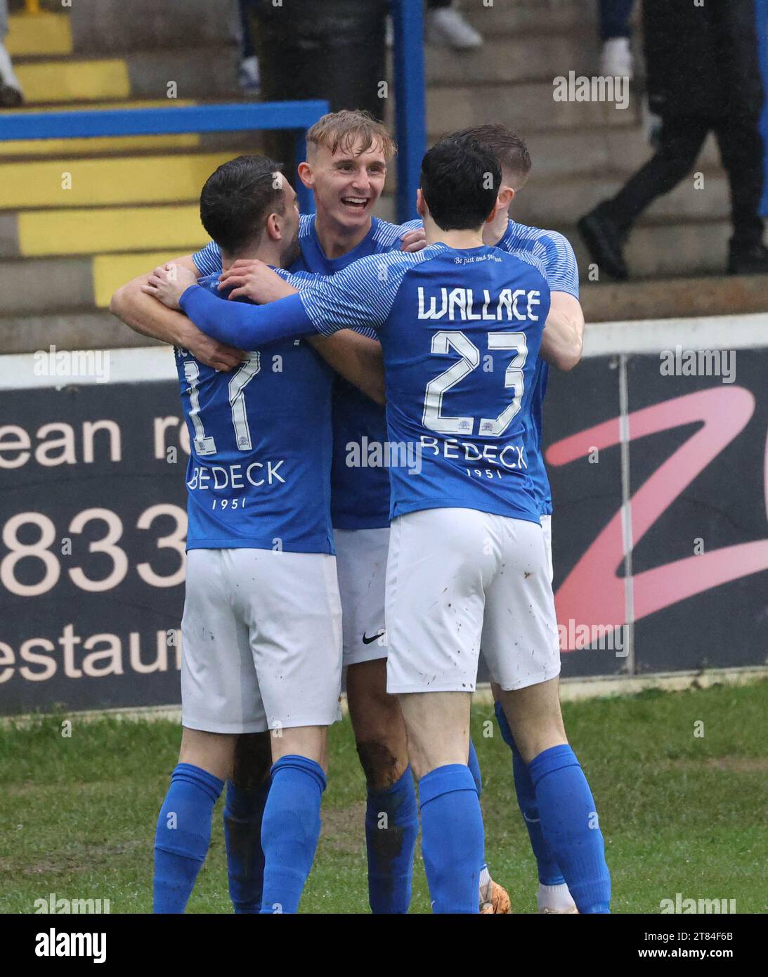 Mourneview Park, Lurgan, County Armagh, Northern Ireland, UK. 18th Nov 2023. Sports Direct Premiership – Glenavon v Loughgall Action from today's game at Mourneview Park (Glenavon in blue). Isaac Baird (16) fires Glenavon ahead in the 03rd minute and celebrates. Credit: CAZIMB/Alamy Live News. Stock Photo