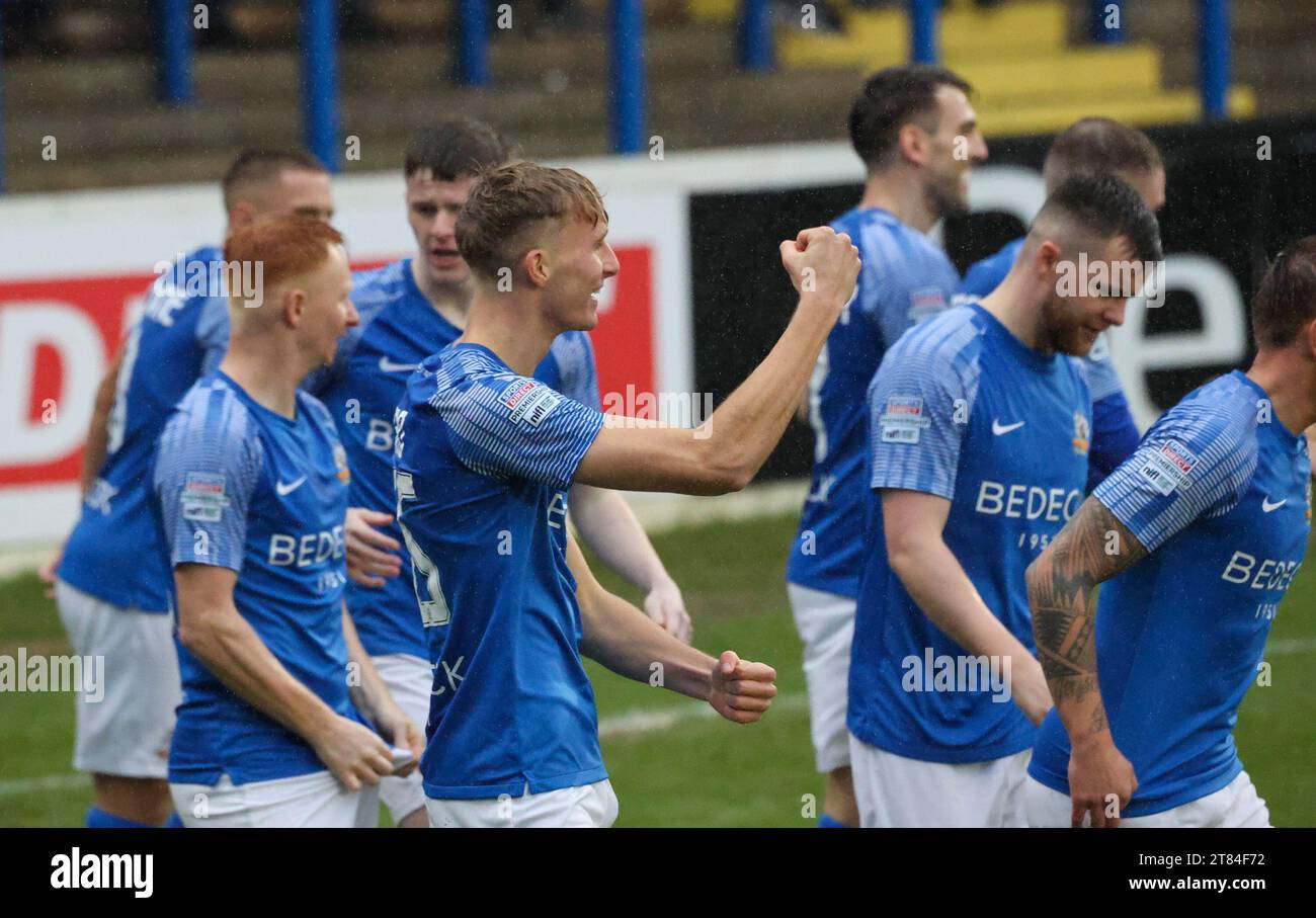 Mourneview Park, Lurgan, County Armagh, Northern Ireland, UK. 18th Nov 2023. Sports Direct Premiership – Glenavon v Loughgall Action from today's game at Mourneview Park (Glenavon in blue). Isaac Baird (16) fires Glenavon ahead in the 03rd minute and celebrates. Credit: CAZIMB/Alamy Live News. Stock Photo