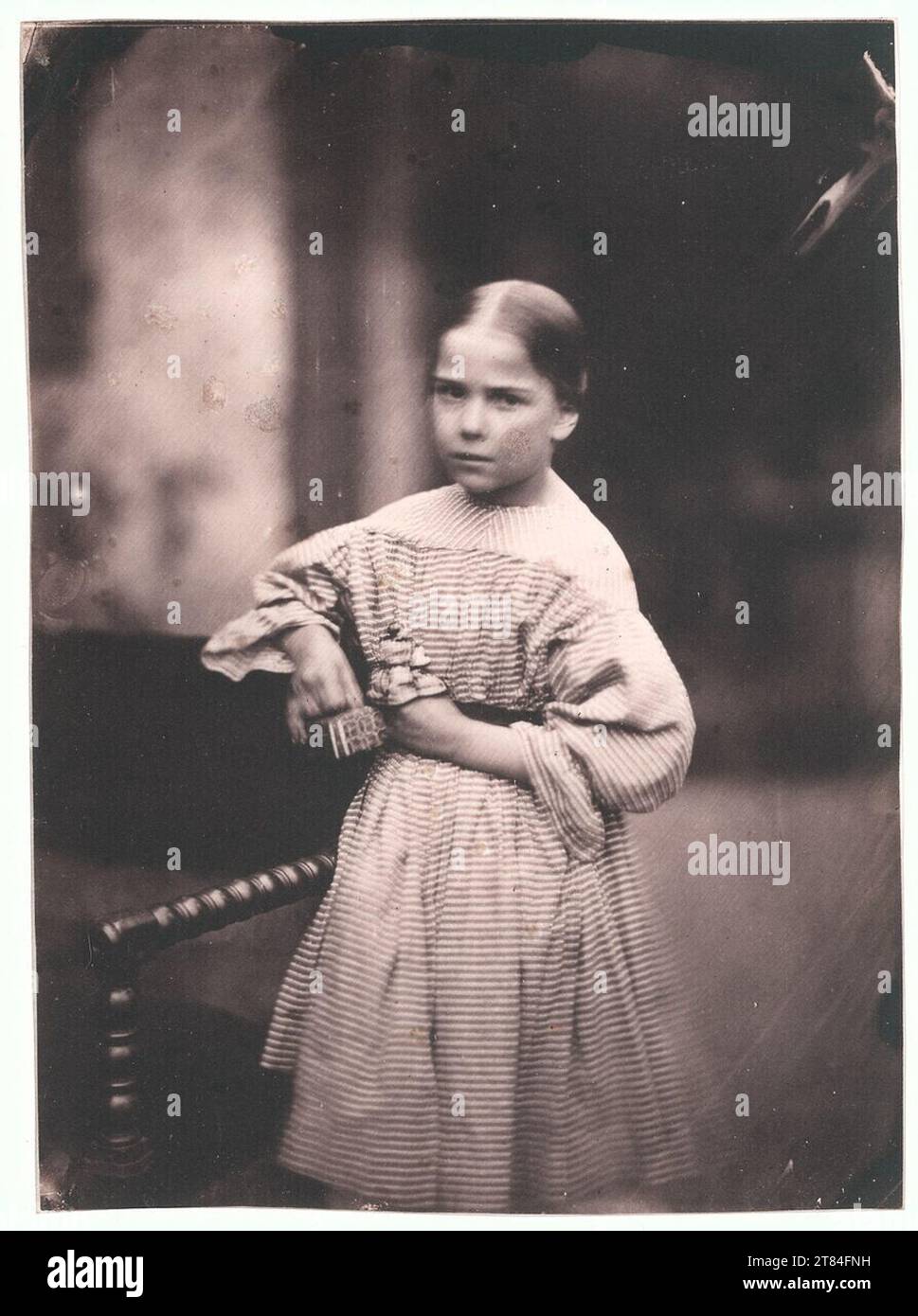 Jean-Baptiste Frénet Girl holding her toys. Salt paper, glued into Passepartout around 1855 Stock Photo