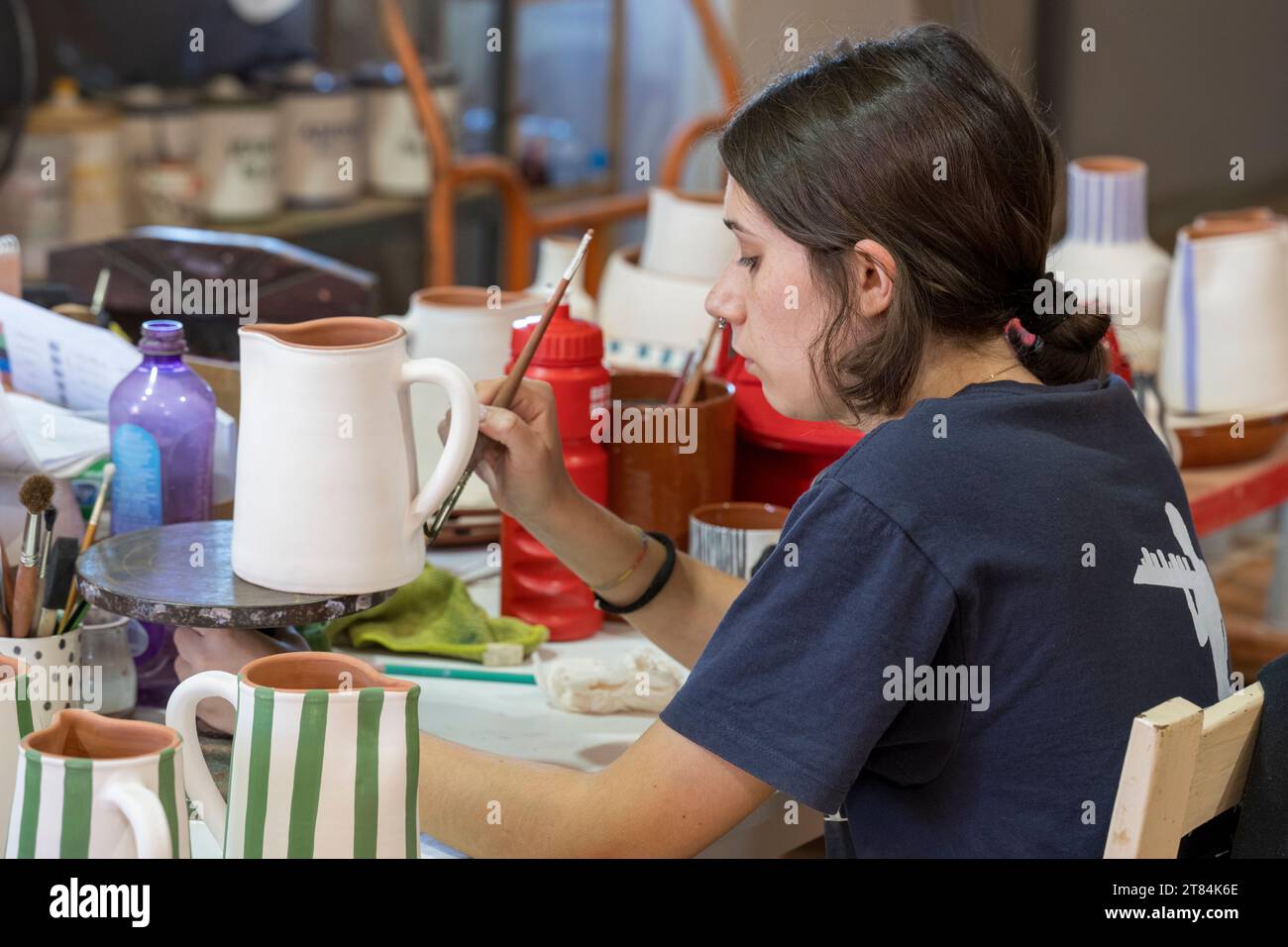 An artisan hand paints traditional Alentejo pottery at Olaria O Patalim ...
