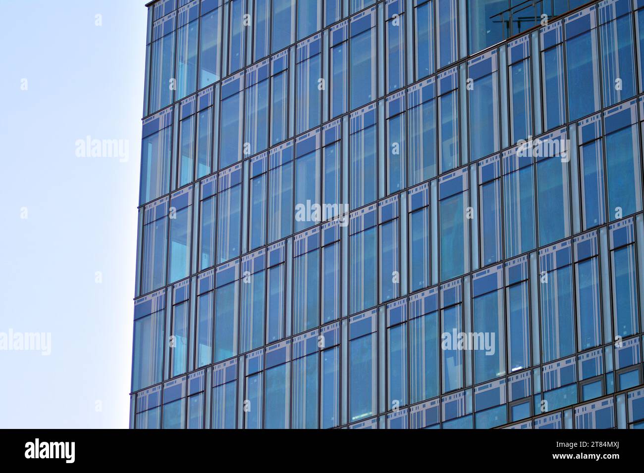 Abstract closeup of the glass-clad facade of a modern building covered ...