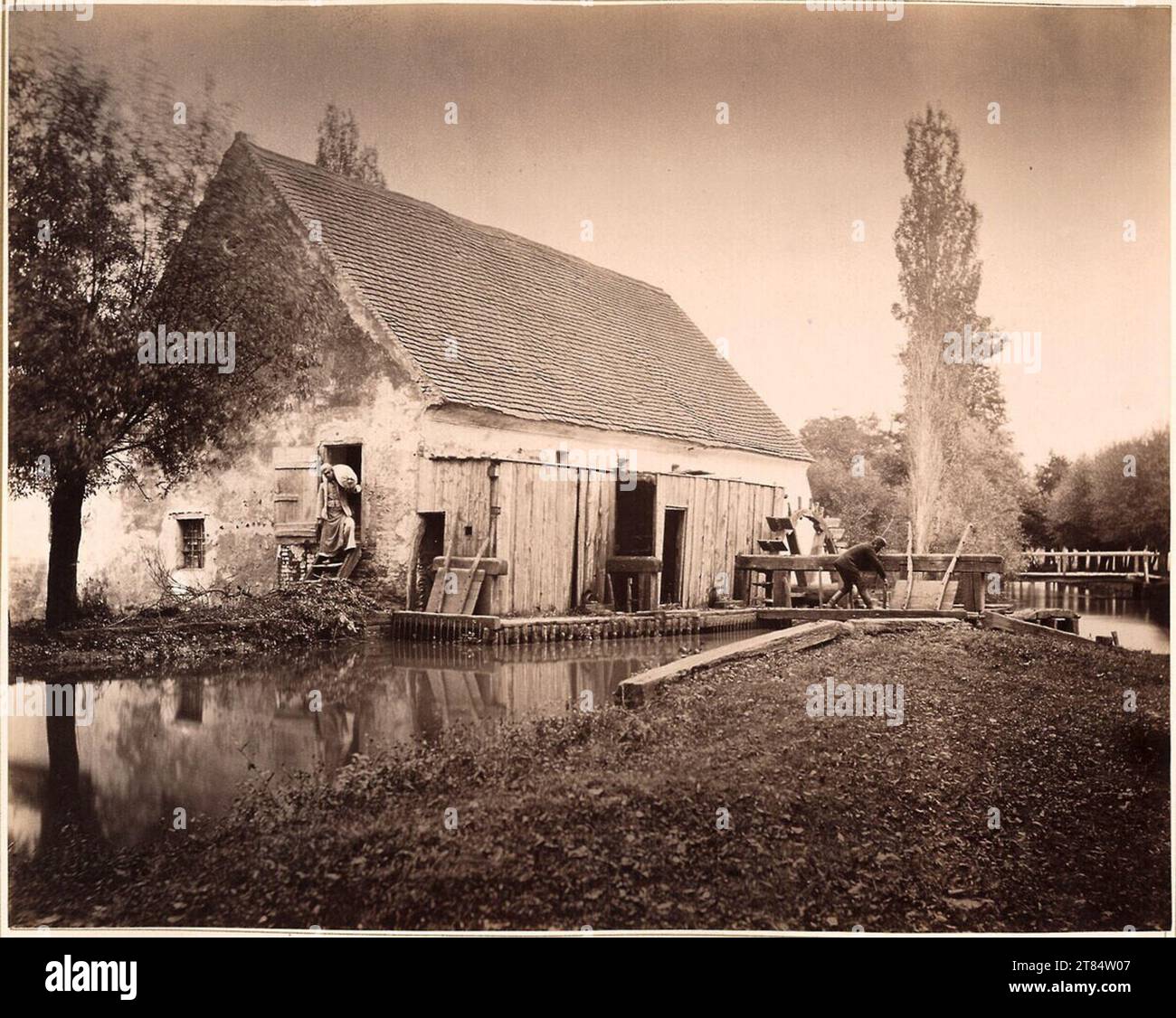 Franz Knebel Mill on the water, with Müller and an employee who is currently working on the lock. Albumin paper, on the box box 1885 , 1885 Stock Photo