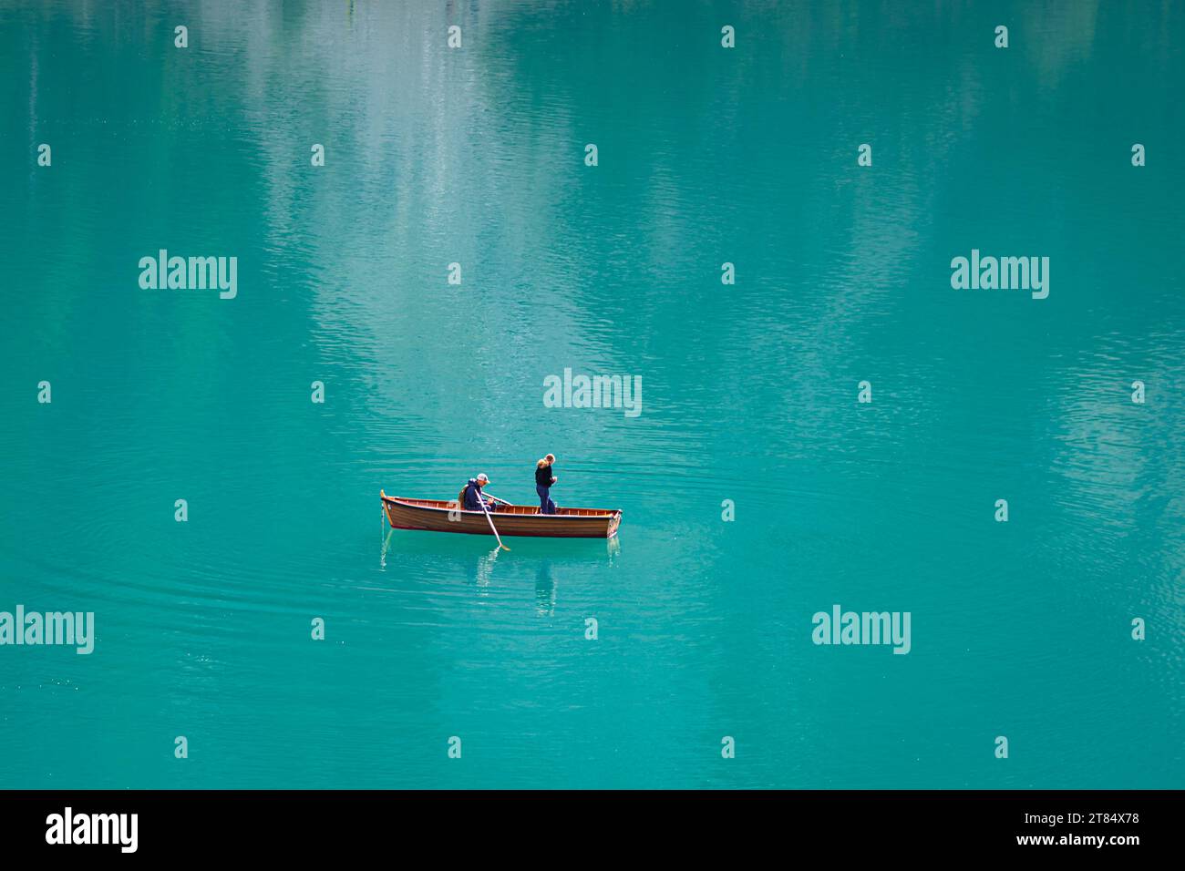 Two people in a rowboat on a blue lake Stock Photo