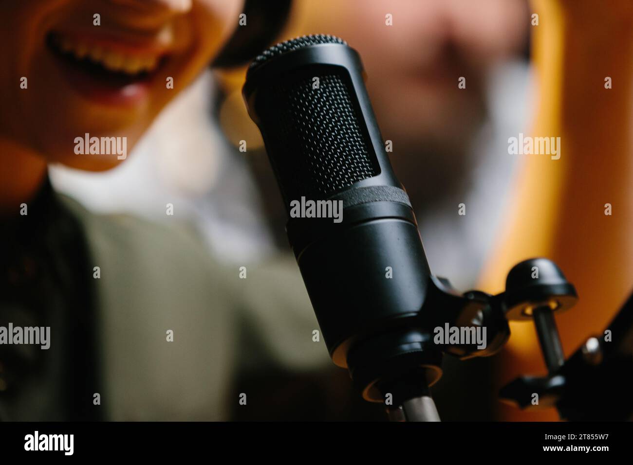Close-up, dubbing actor or radio host speaking into a microphone. Stock Photo