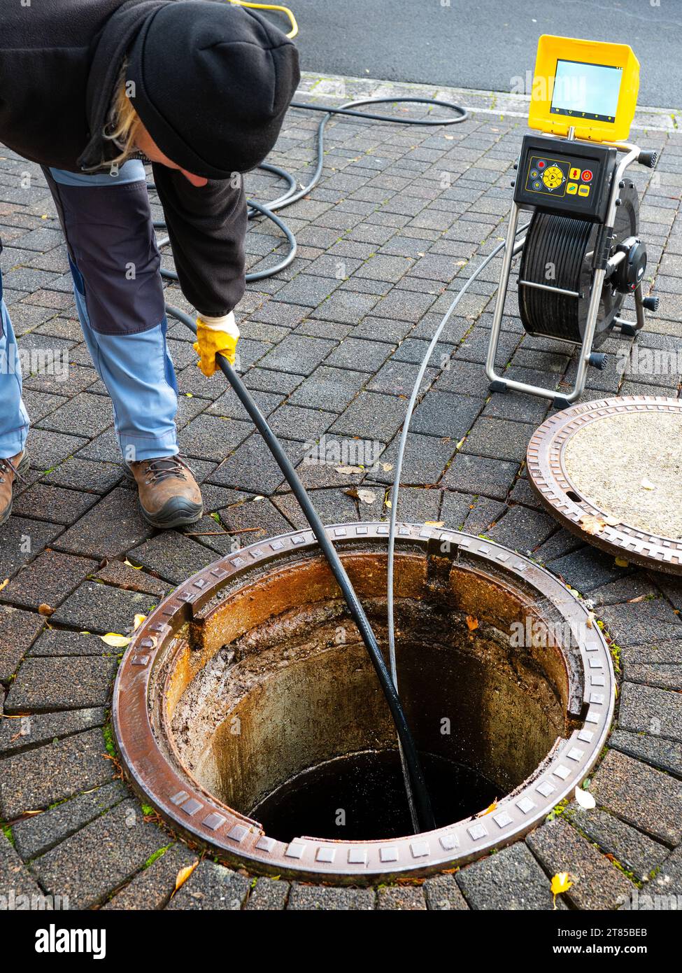 A drain cleaning company checks a blocked drain with a camera before flushing it out Stock Photo