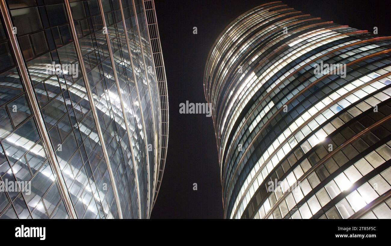 Pattern of office buildings windows illuminated at night. Glass ...