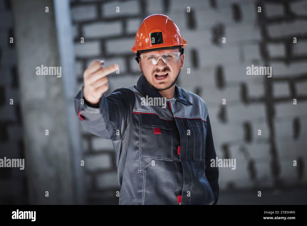 Portrait of an emotional angry construction worker Stock Photo - Alamy