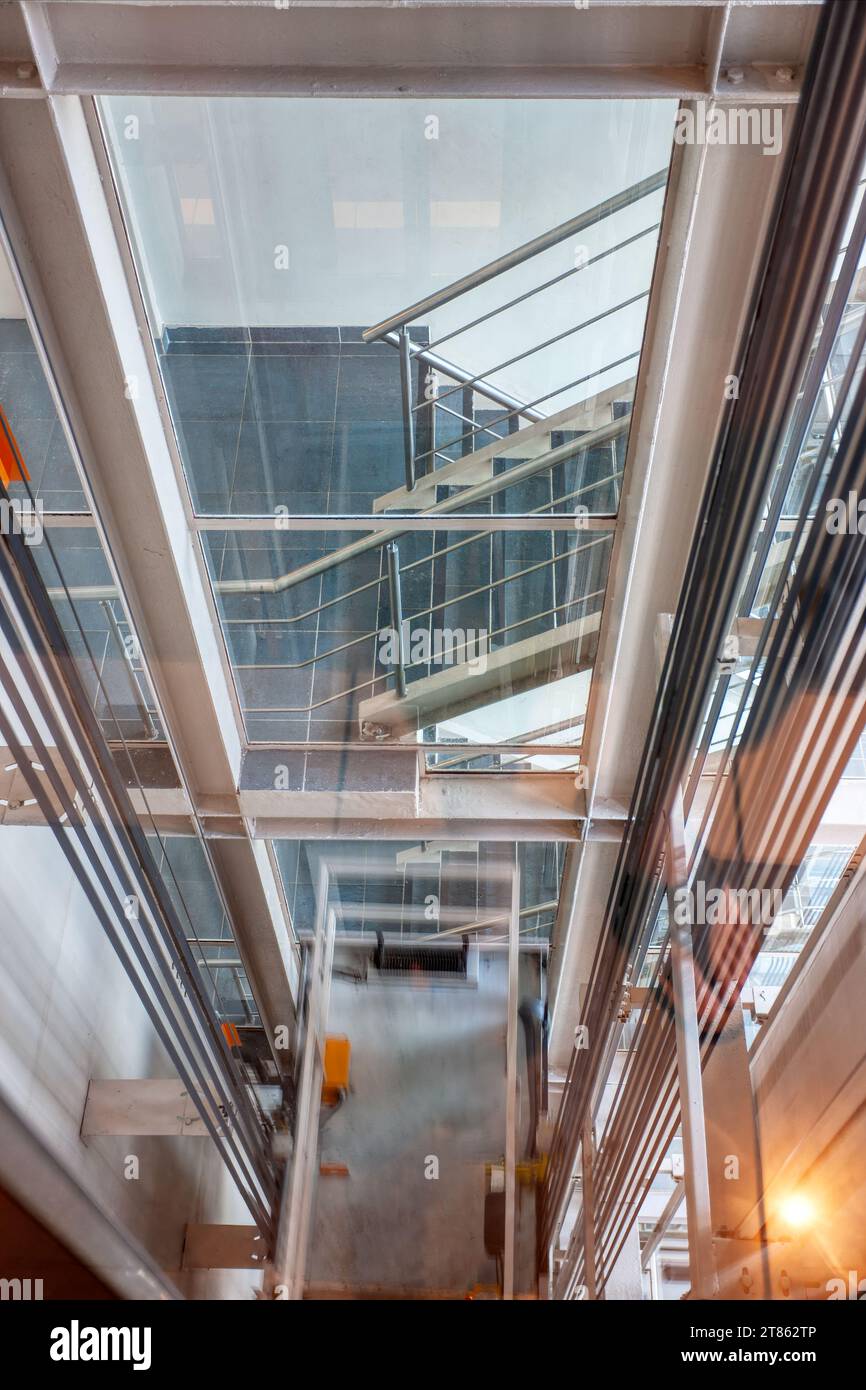 elevator shaft down view trough the glass of the staircase Stock Photo