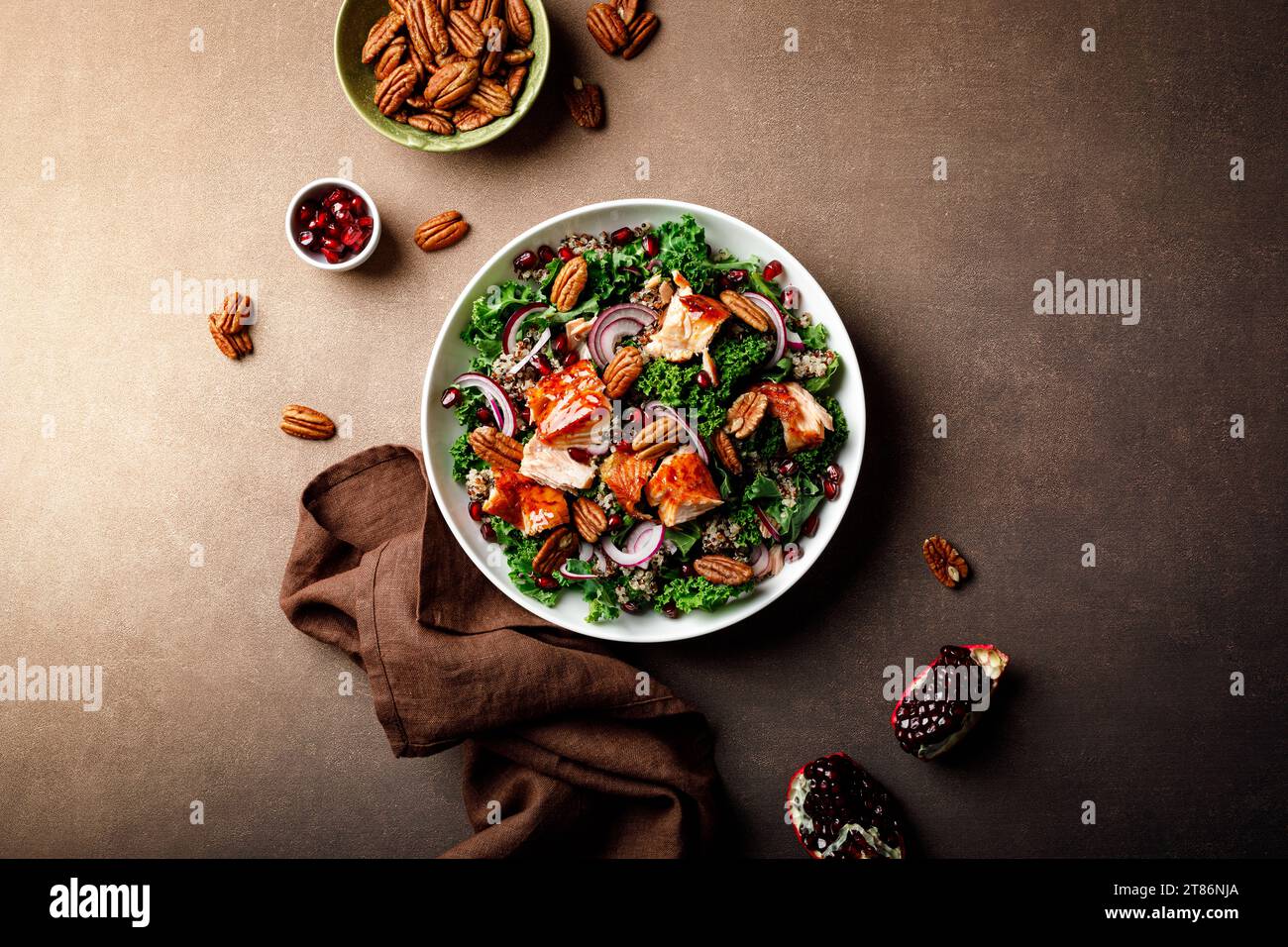 Salmon superfood salad with grilled fish, kale, quinoa, pecan nuts, red onion and pomegranate. Top view Stock Photo