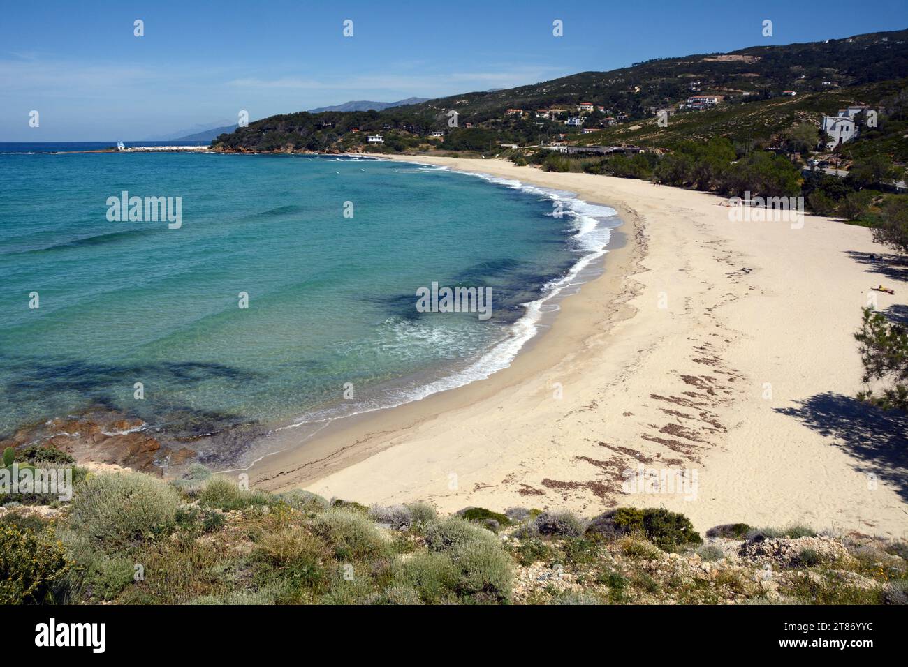A sandy beach between Armenistis and Gialiskari on the north coast of the Greek island of Ikaria, a 'blue zone' in the Aegean Sea, in Greece. Stock Photo