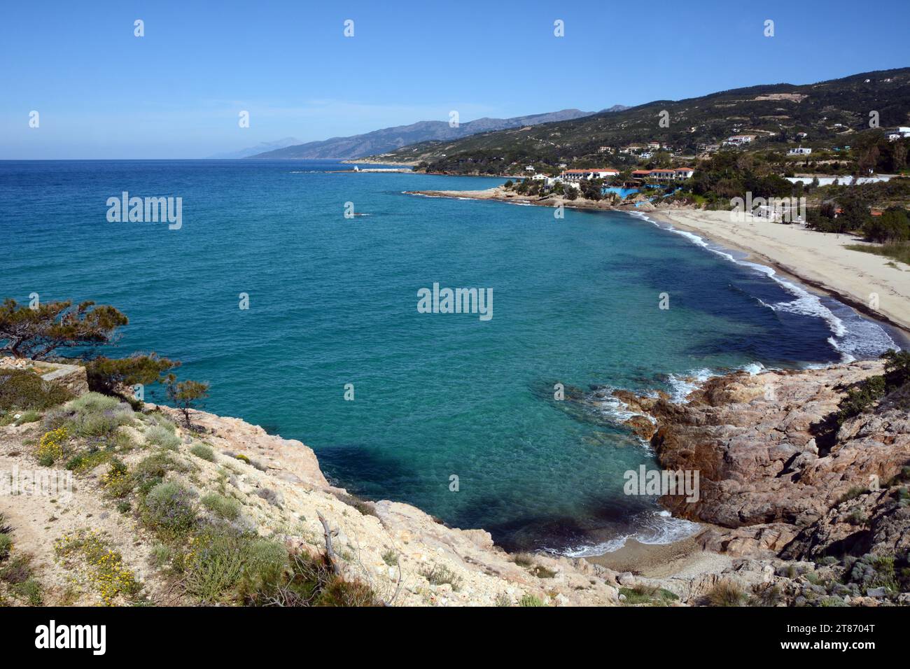 A sandy beach between Armenistis and Gialiskari on the north coast of the Greek island of Ikaria, a 'blue zone' in the Aegean Sea, in Greece. Stock Photo