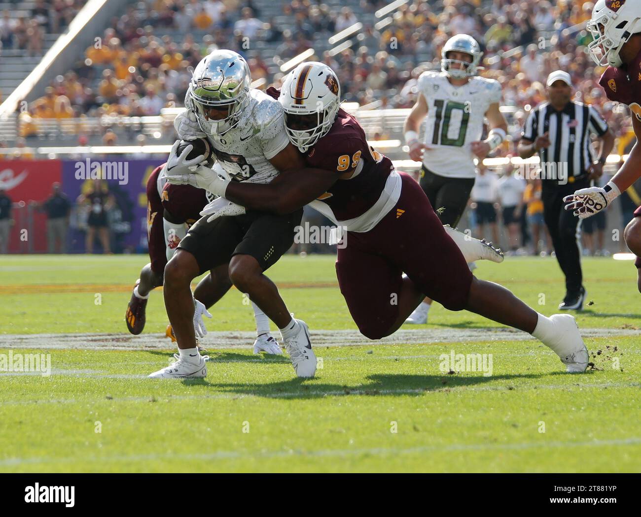 November 18, 2023: Running back Bucky Irving (0) of the Oregon Ducks is tackled by defensive lineman C.J. Fite (99) of the Arizona State Sun Devils during the NCAA football game between Oregon Ducks and Arizona State University at Mountain America Stadium in Tempe, Arizona. Michael Cazares/CSM. Stock Photo