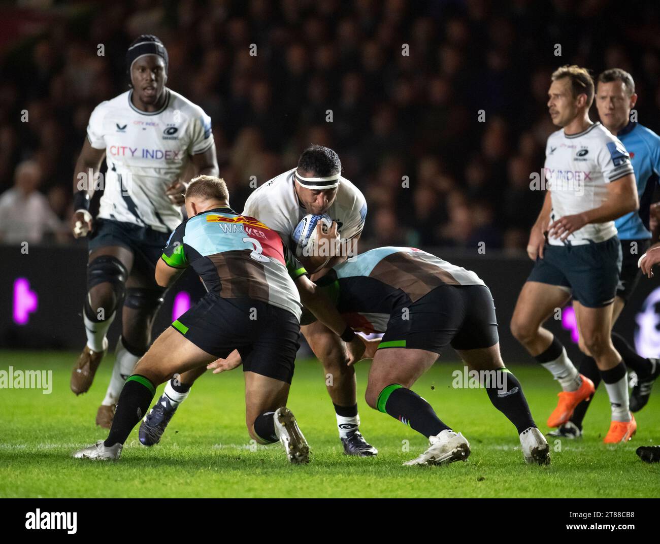 Saracens Mako Vunipola being tackled by Harlequins' Jack Walker and Joe ...