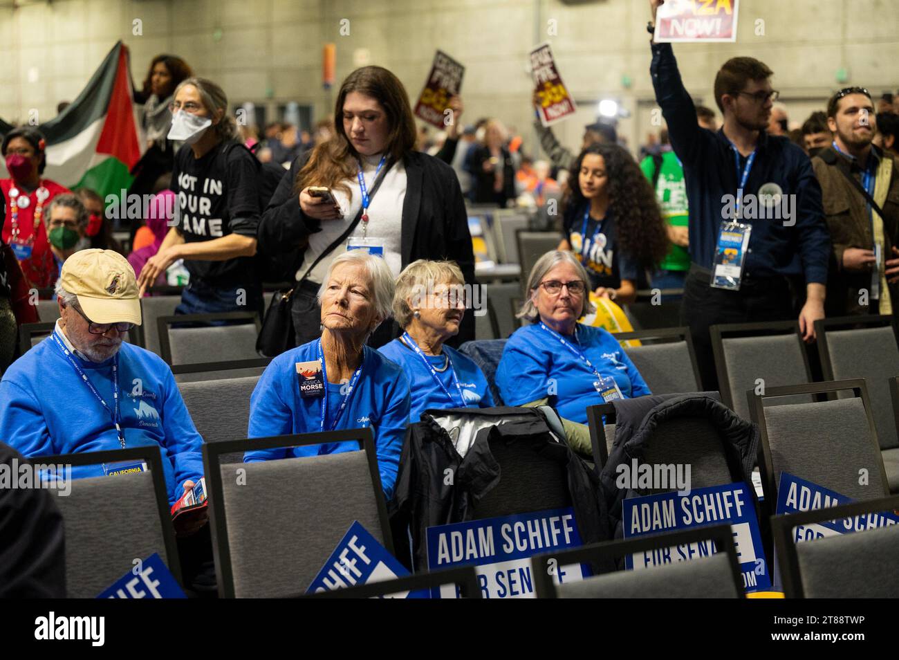 Sacramento, CA, USA. 18th Nov, 2023. Convention members sit in chairs as Pro-Palestinian demonstrators carry signs and chant and interrupt the 2023 California Democratic Party November State Endorsing Convention on Saturday, Nov. 18, 2023, at SAFE Credit Union Convention Center in Sacramento. The demonstrators want to bring an end to the ongoing assault on Palestinians in Gaza by the Israeli government. (Credit Image: © Paul Kitagaki Jr./ZUMA Press Wire) EDITORIAL USAGE ONLY! Not for Commercial USAGE! Stock Photo