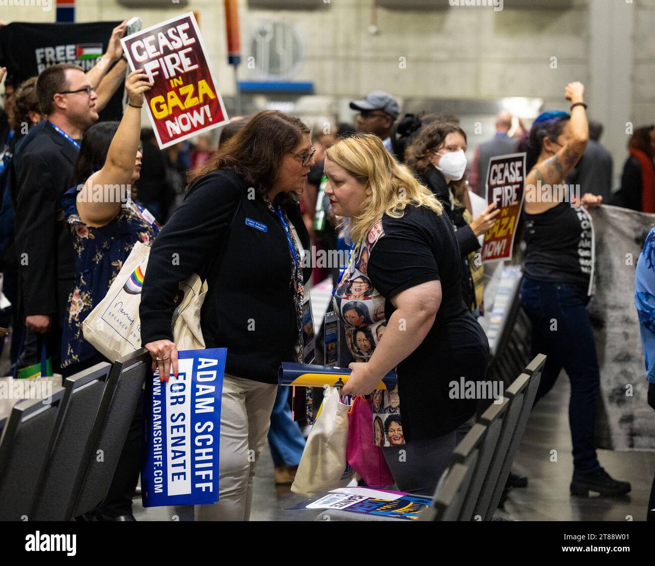 Sacramento, CA, USA. 18th Nov, 2023. Adam Schiff supporters Stacy Fortier and Keely talk as Pro-Palestinian demonstrators carry signs and chant interrupting the 2023 California Democratic Party November State Endorsing Convention on Saturday, Nov. 18, 2023, at SAFE Credit Union Convention Center in Sacramento. The demonstrators want to bring an end to the ongoing assault on Palestinians in Gaza by the Israeli government. (Credit Image: © Paul Kitagaki Jr./ZUMA Press Wire) EDITORIAL USAGE ONLY! Not for Commercial USAGE! Stock Photo