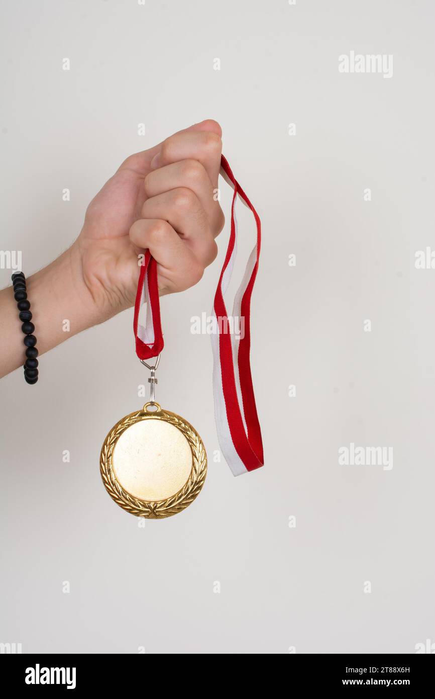 Golden medal with red and white ribbon Stock Photo - Alamy
