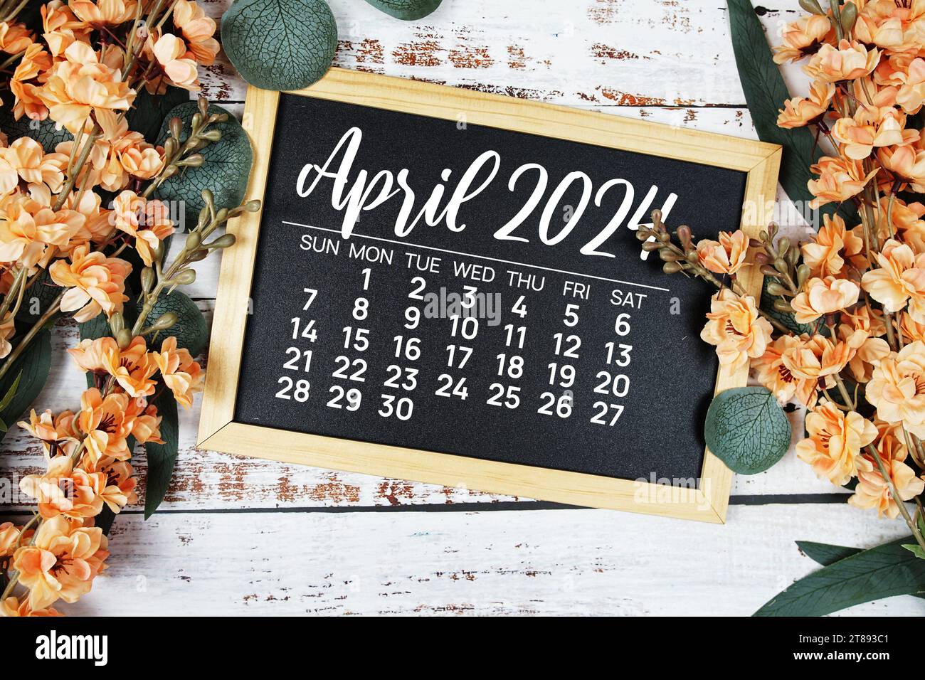 April 2024 monthly calendar with flower bouquet decoration on wooden