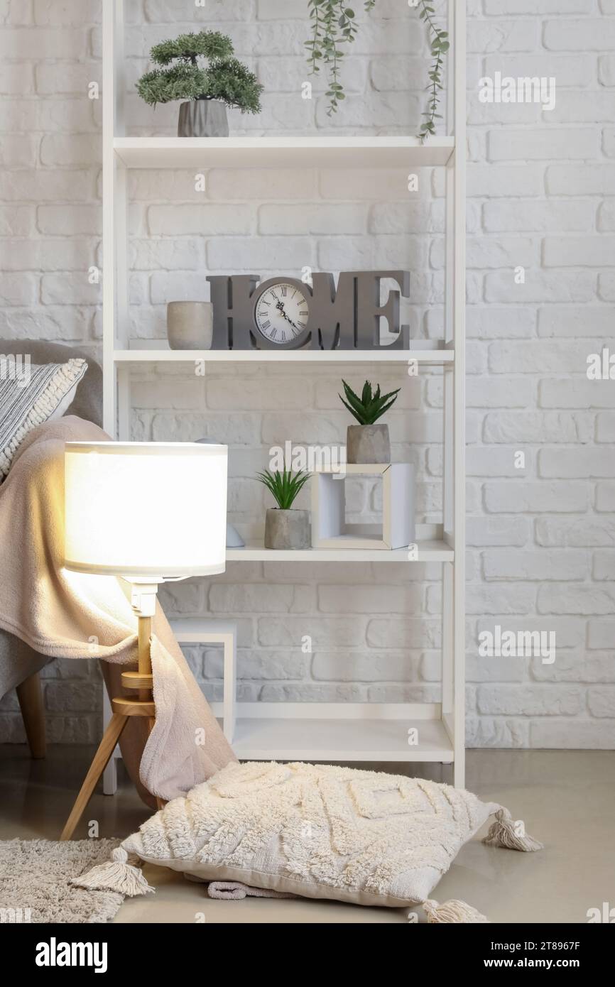 Interior of living room with cozy grey sofa and glowing lamp Stock ...