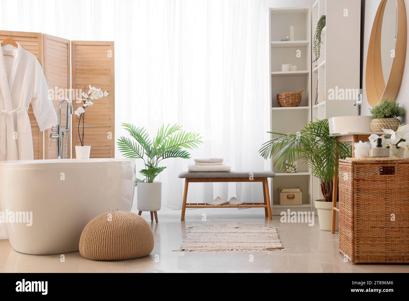 Interior of light bathroom with grey bench and bathtub Stock Photo - Alamy