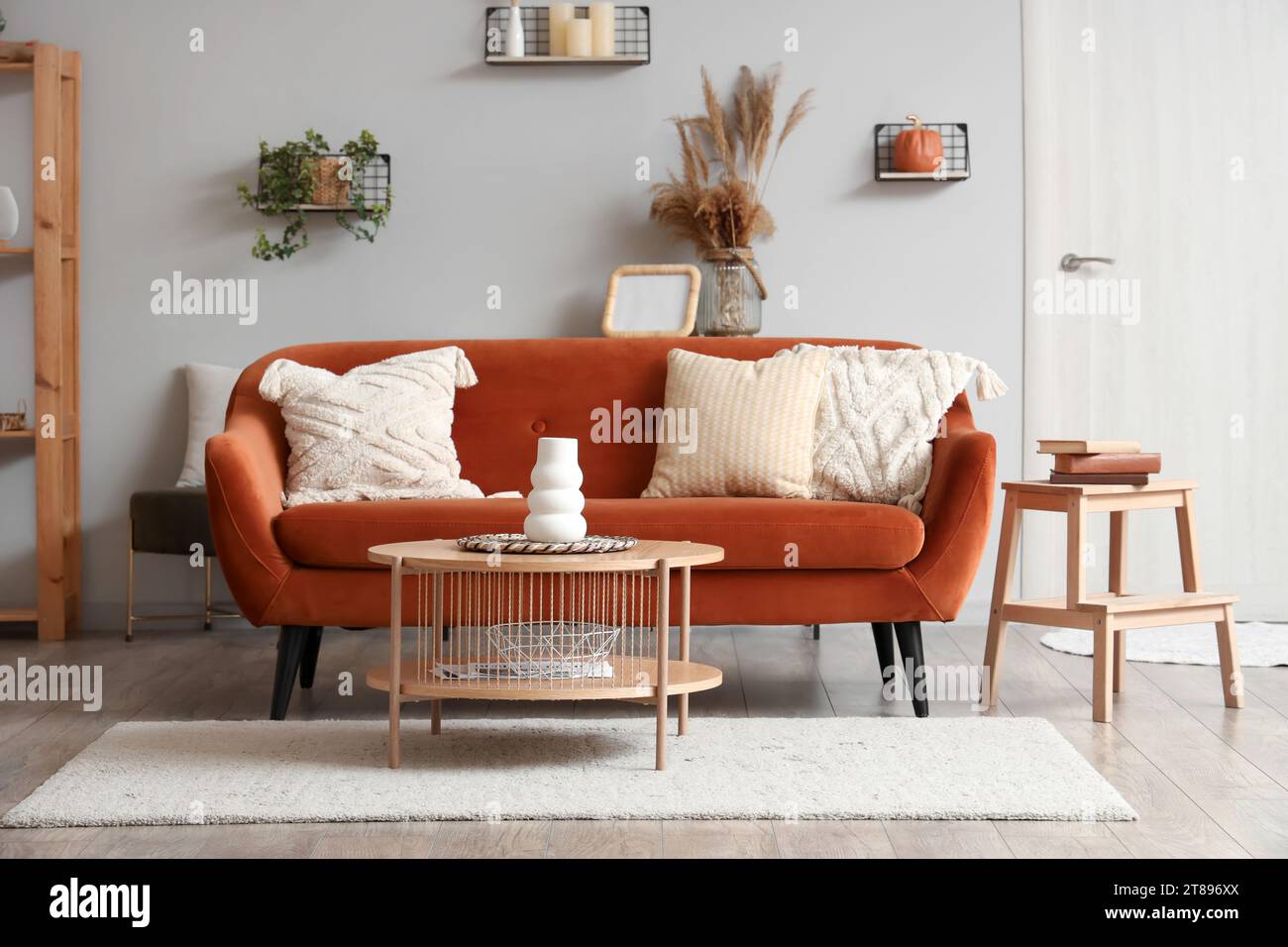 Interior of modern living room with brown sofa and wooden coffee table ...