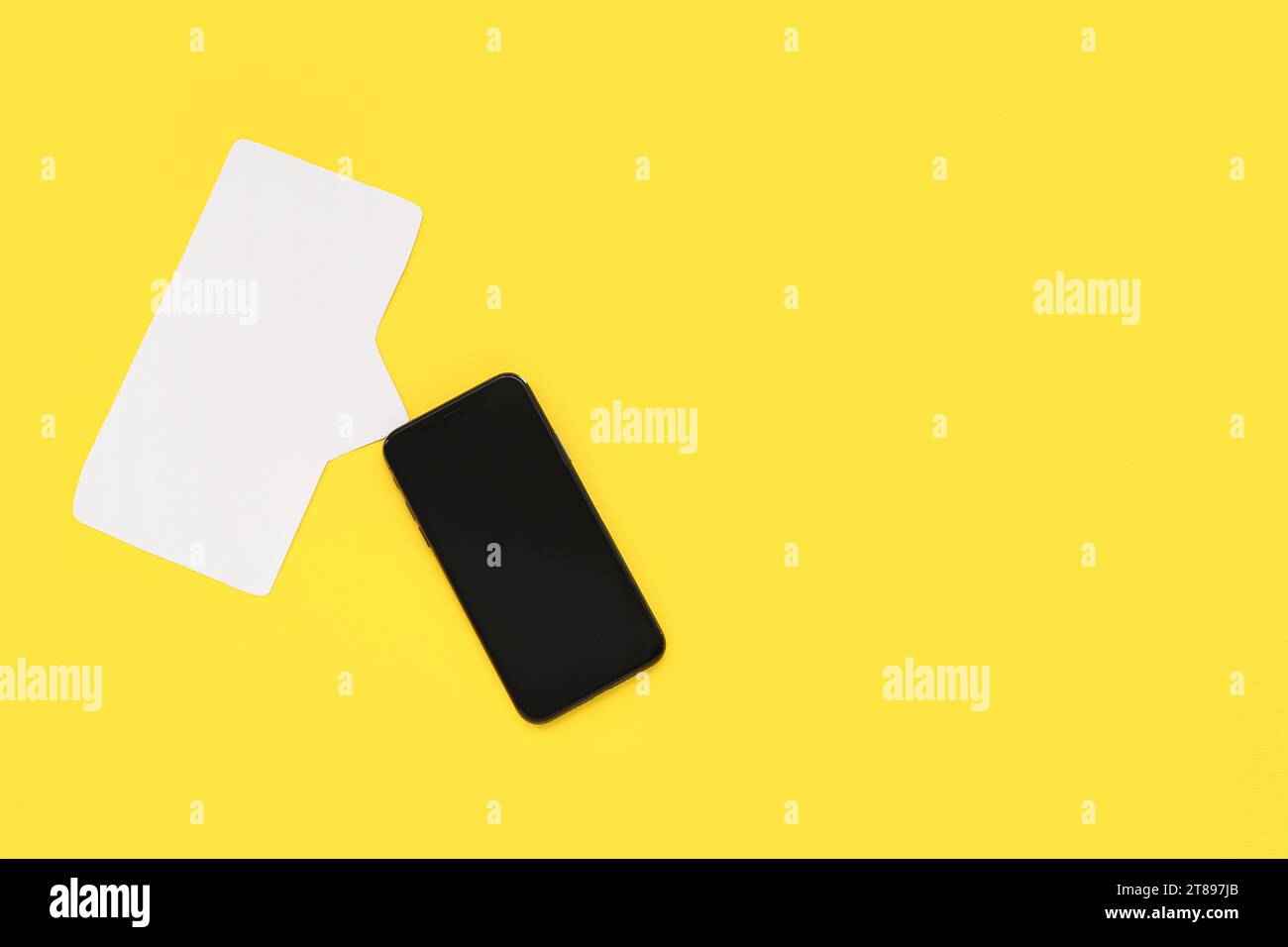 Mobile phone with empty screen and blank speech bubble on yellow background Stock Photo