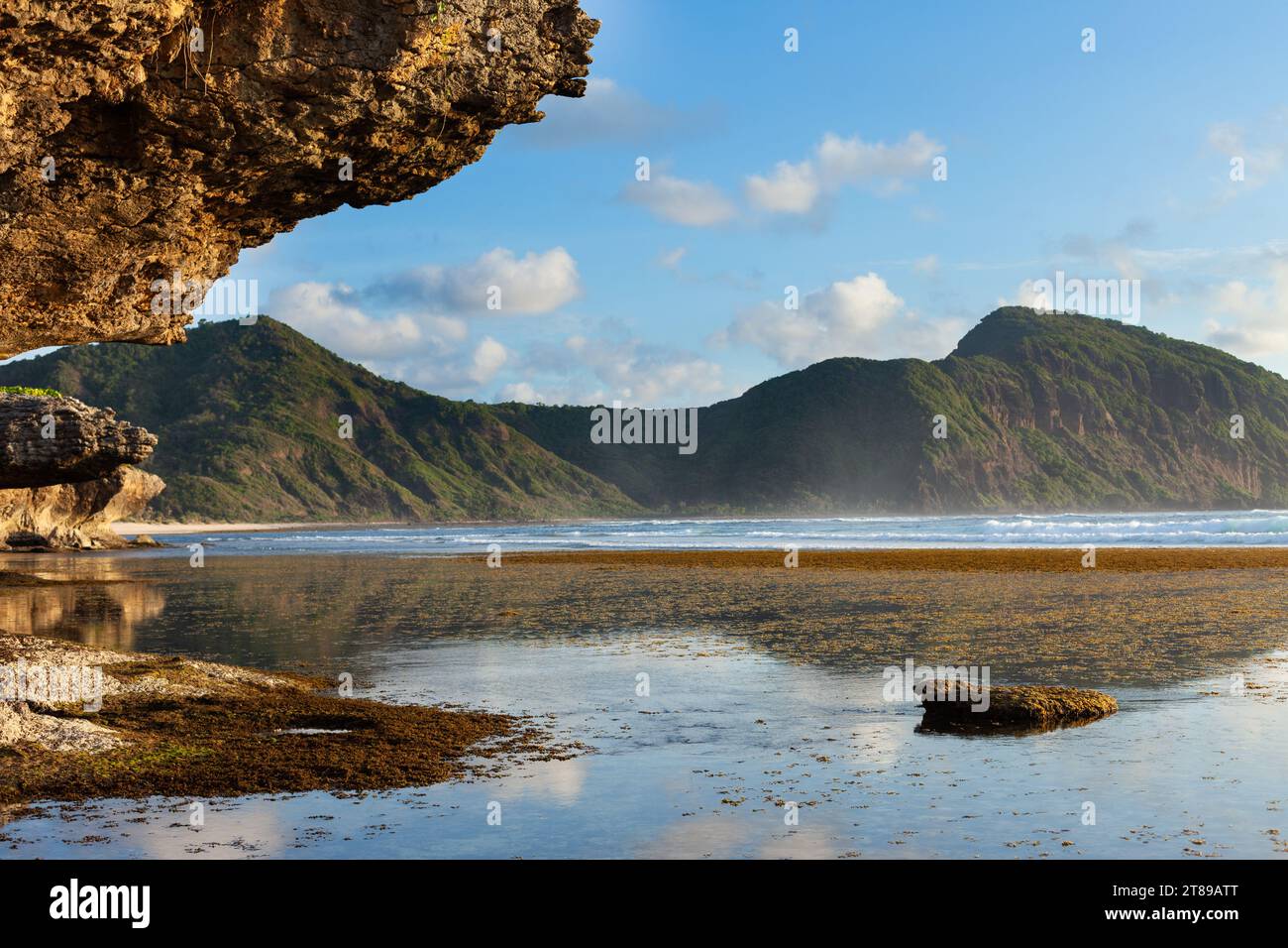Rocks, coral reefs, and sunset off Sumbawa Island, Indonesia Stock ...