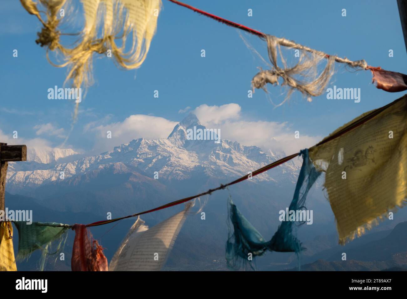 Tibetan prayer flags hang over a view of Machhapuchhare and the Seti