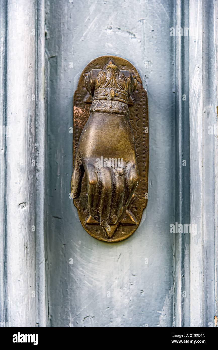Background from an old blue wooden door with a bronze handle in the shape of a hand with a star of David. Stock Photo