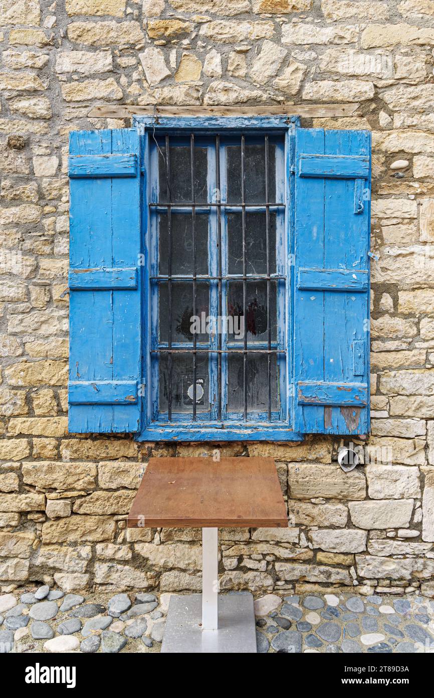 Old window with metal bars and blue open shutters in Limassol. Cyprus ...