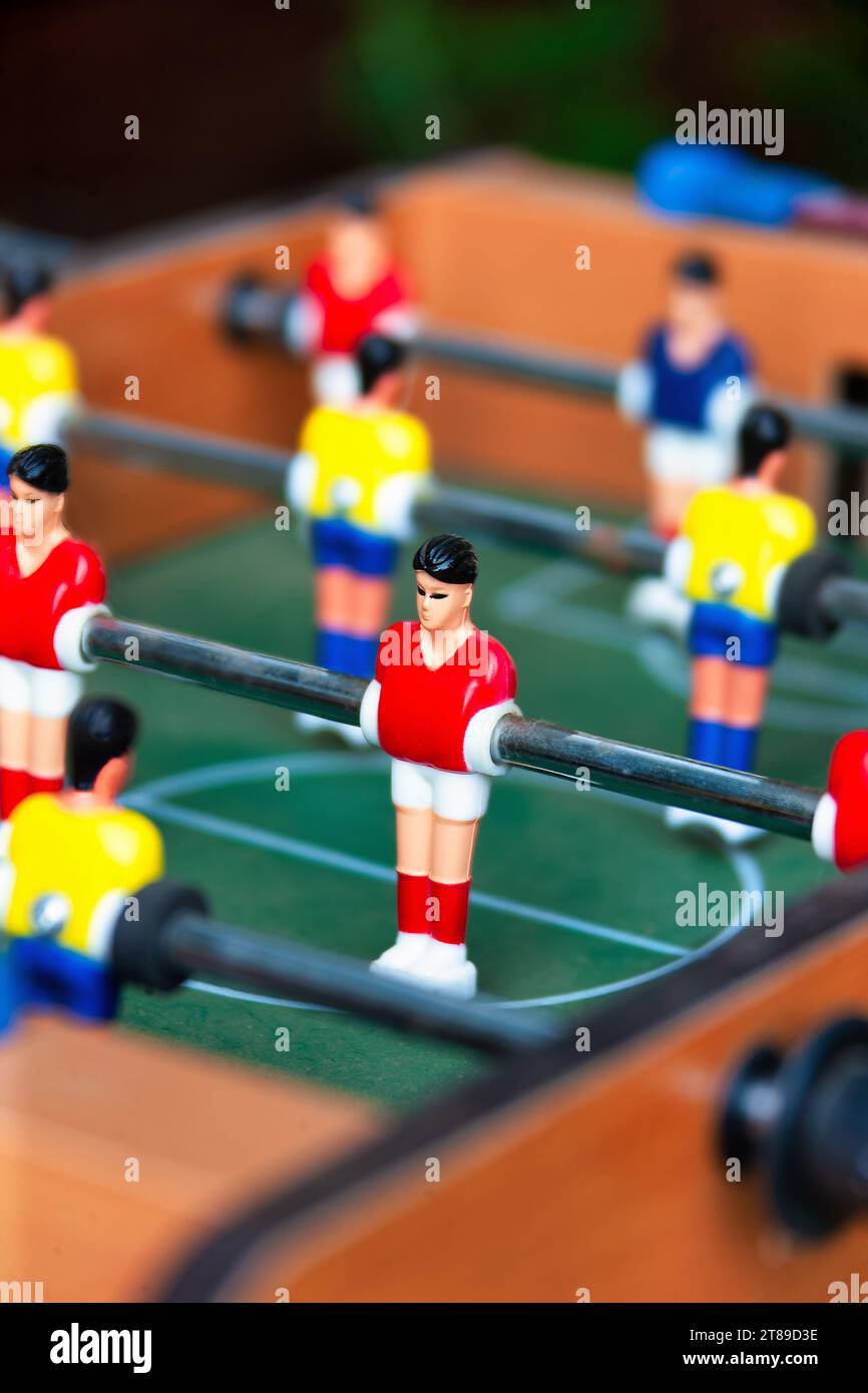 Table football, also known as foosball or table soccer, is a tabletop game that is loosely based on association football Stock Photo