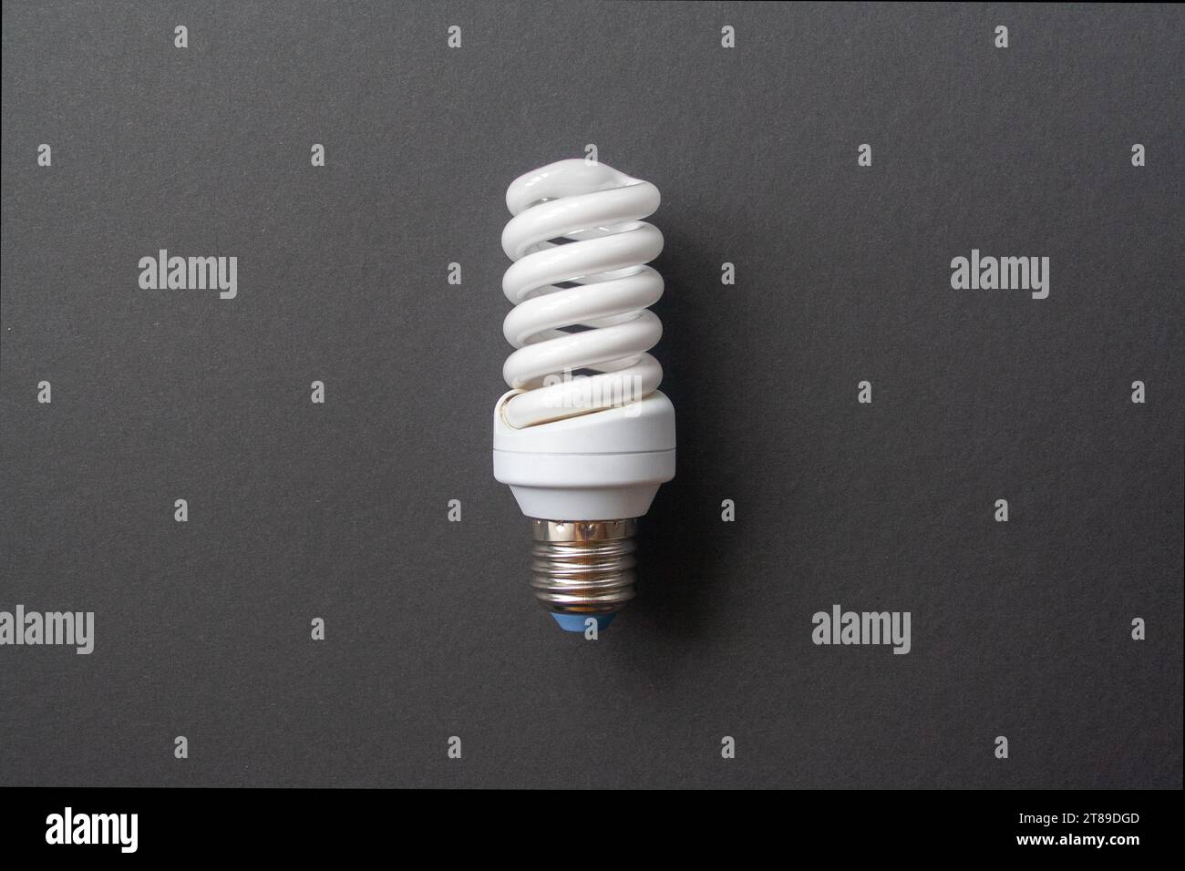 Energy saving light bulb on a black background Stock Photo - Alamy