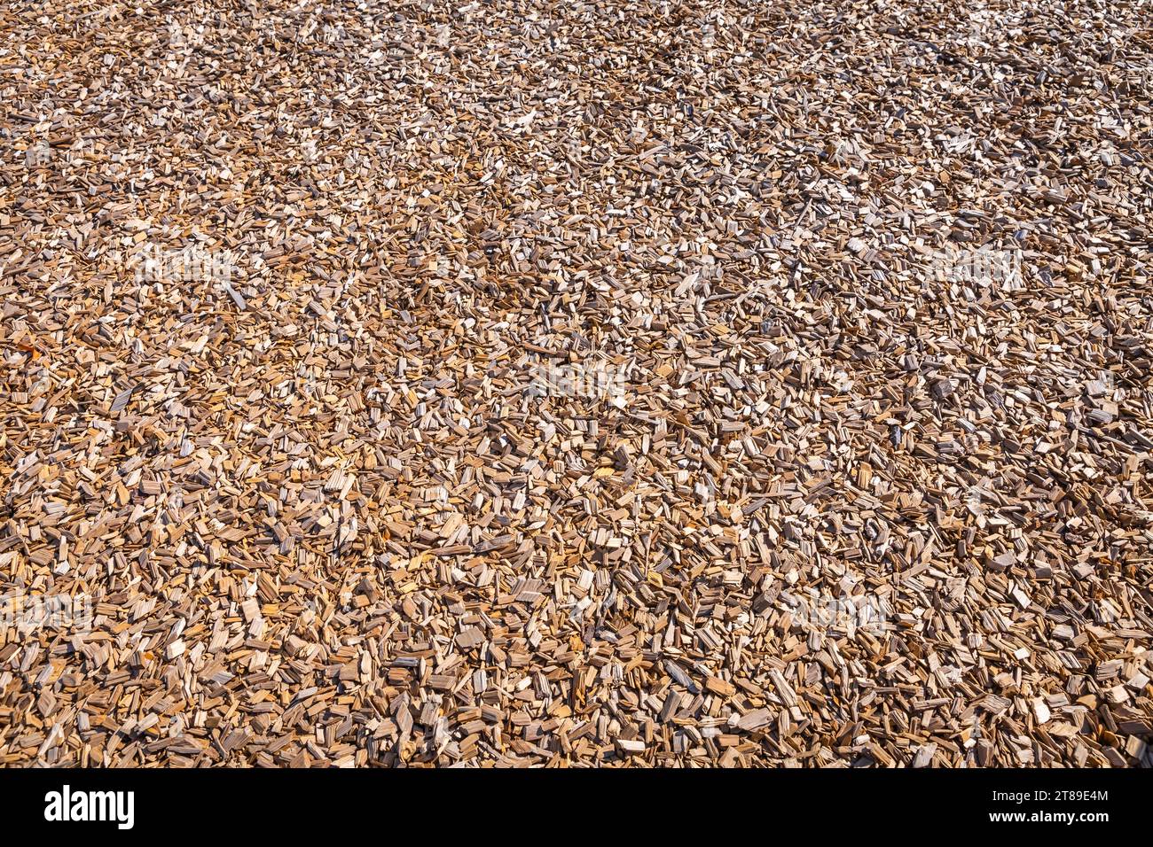 Woodchips used as safe soft surface for a playground or against weeds in a garden, bark mulch Stock Photo