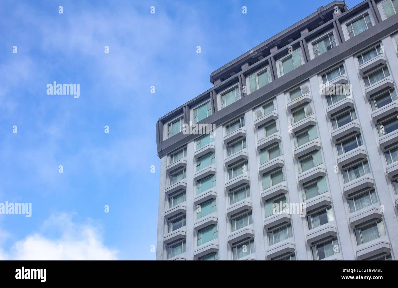 A high rise building with blue sky in background Stock Photo - Alamy