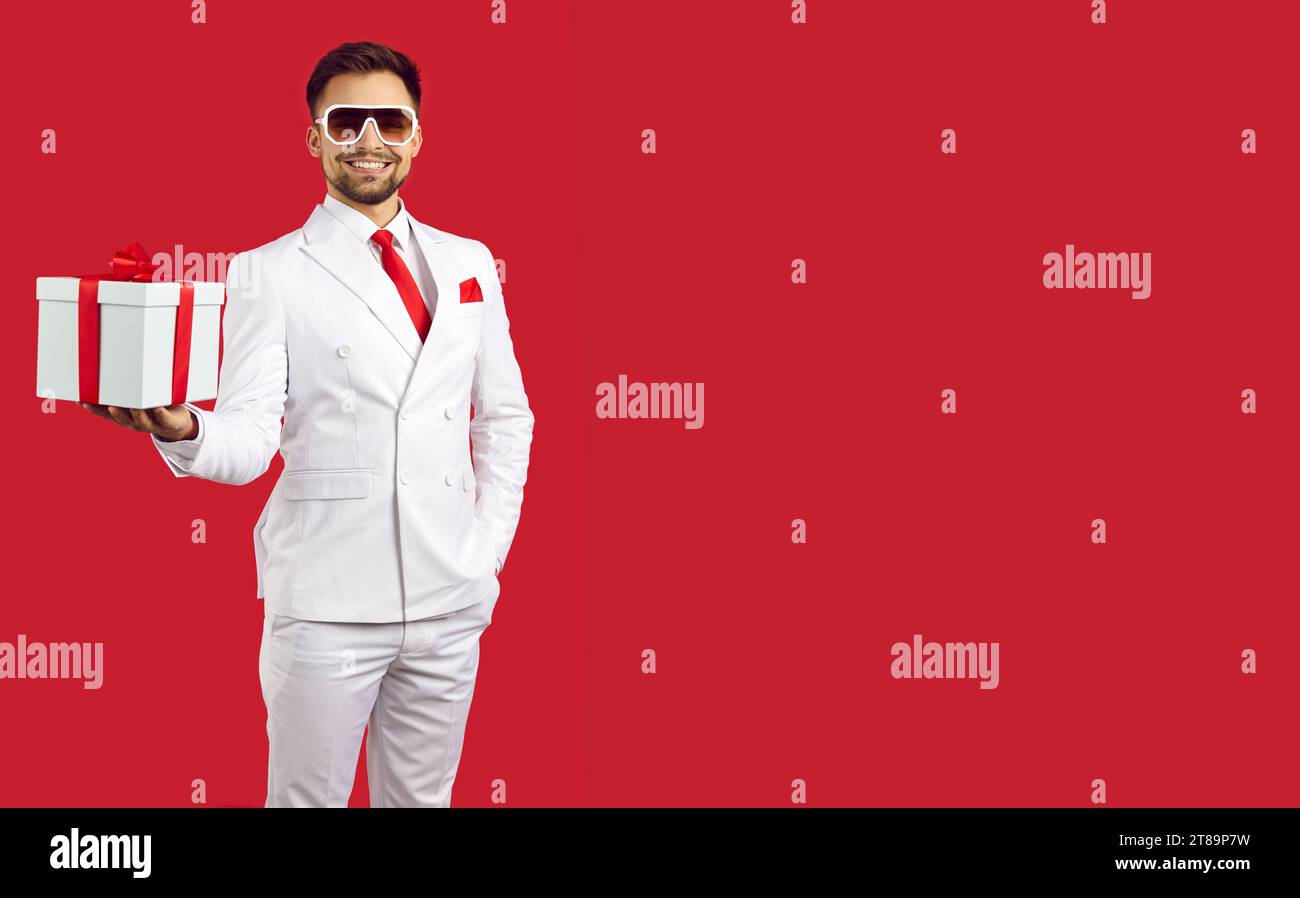 Happy man in suit greeting with gift box Stock Photo