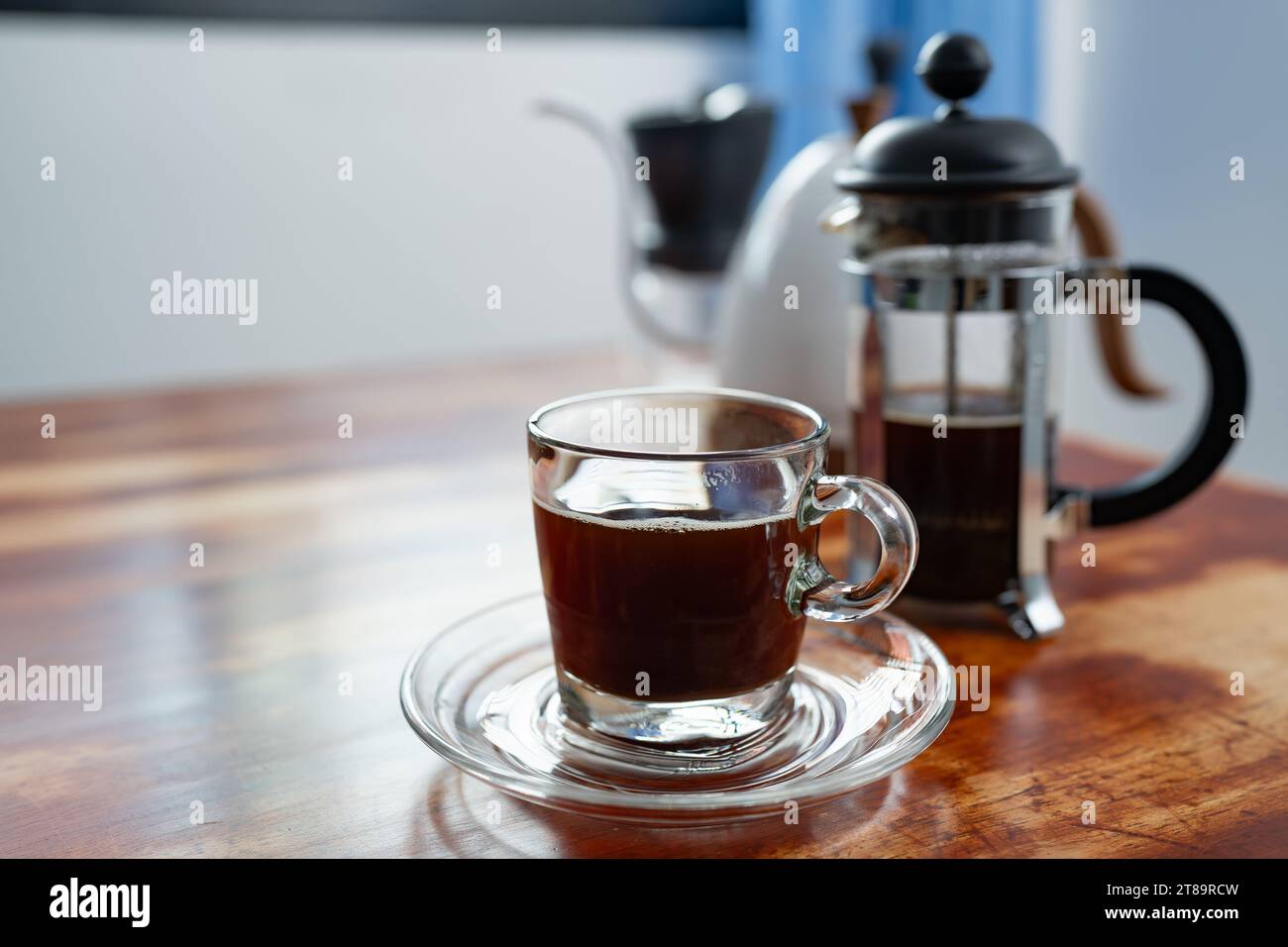 A cup of French press coffee on a table Stock Photo