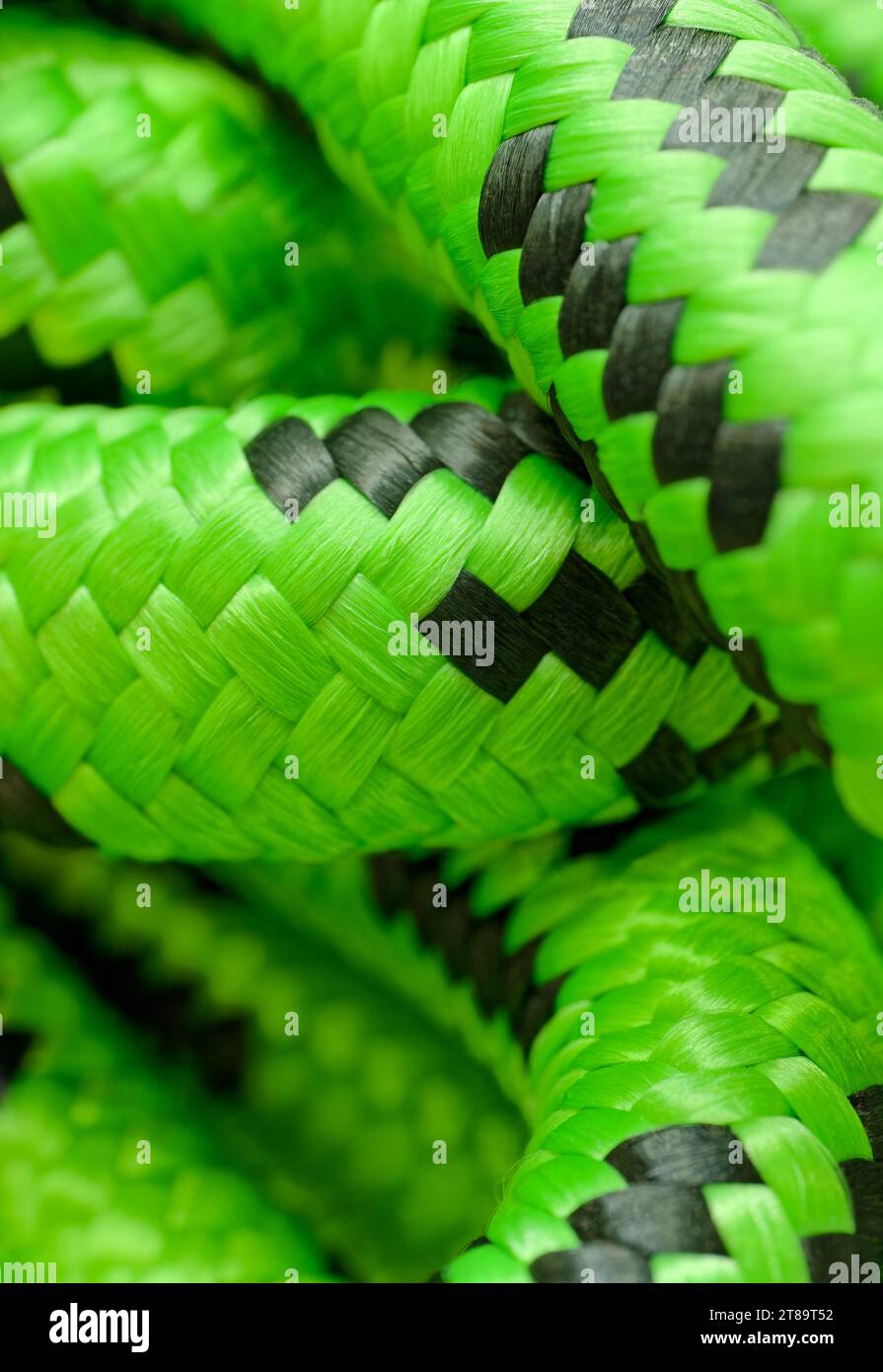Tangled green nylon cord, close-up shot, abstract nautical or mountaineering background Stock Photo
