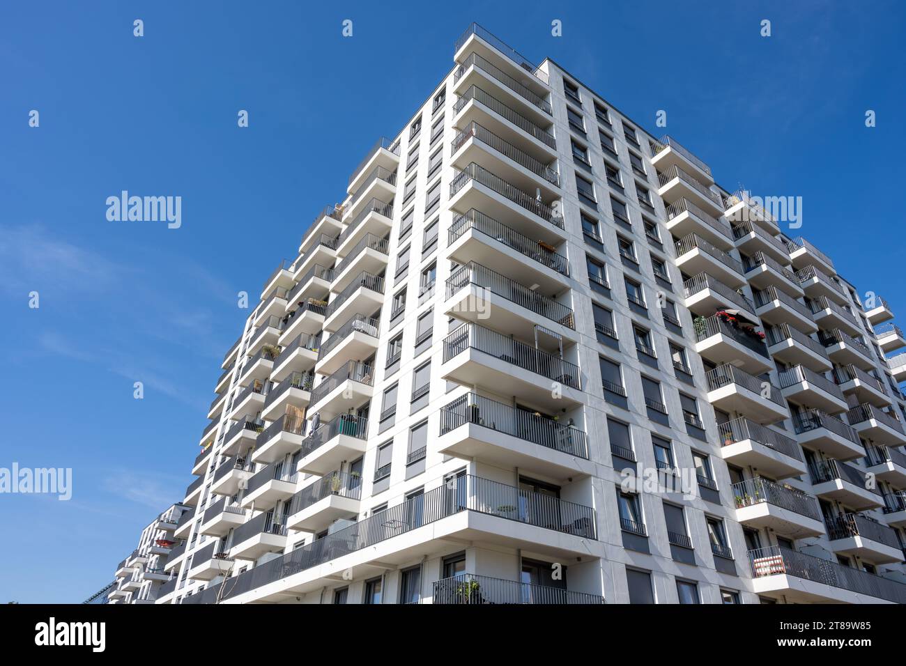 Big white apartment building with balconies seen in Berlin, Germany Stock Photo