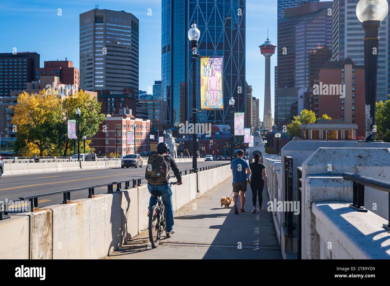 Calgary, Alberta, Canada - October 8 2023 : Pedestrian on the Centre Street Bridge. Downtown Calgary skyline in background. Stock Photo