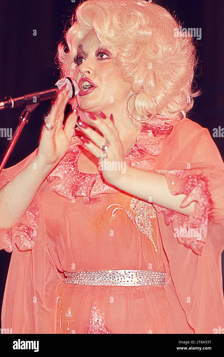 Dolly Parton on stage singing and clapping during her 1978 summer