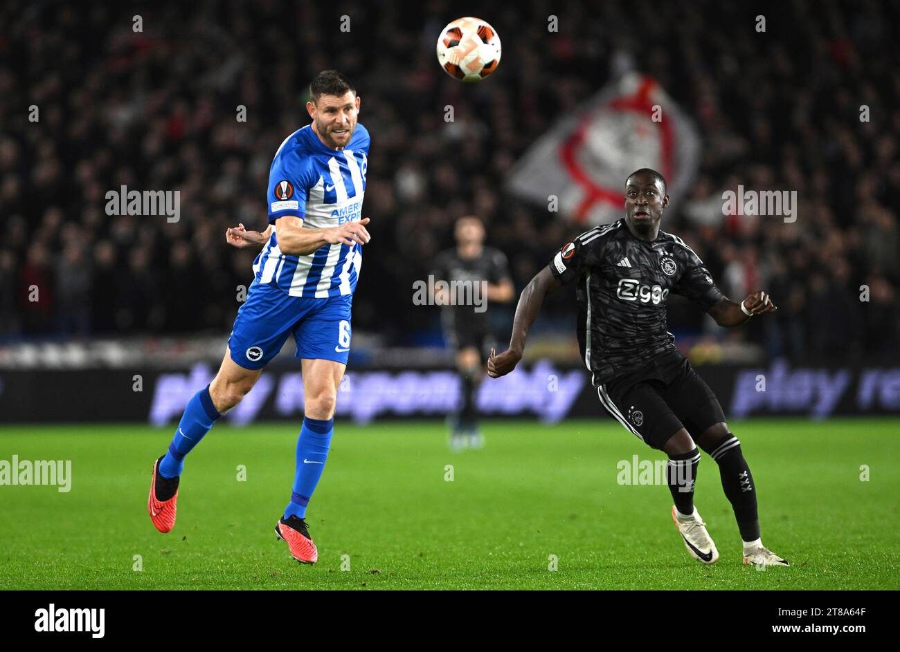 Brighton’s James Milner and Ajax’s Carlos Forbs battle it out during Brighton and Hove Albion v AFC Ajax - UEFA Europa League Group B football match at the American Express Community Stadium, Brighton UK on Thursday October 26th 2023 Stock Photo