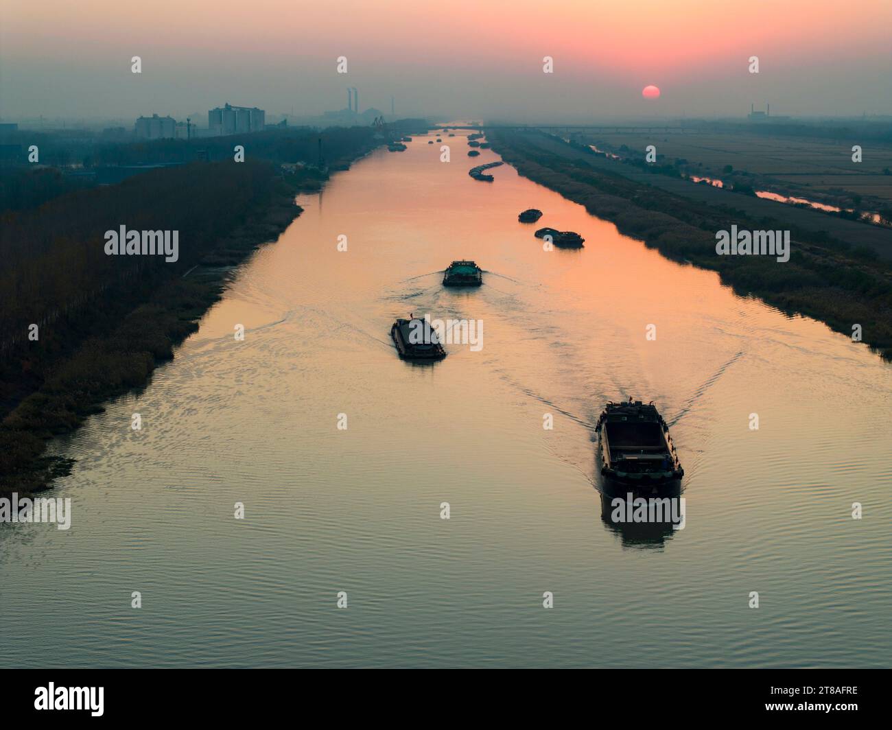 HUAI'AN, CHINA - NOVEMBER 19, 2023 - Cargo ships sailing in the main irrigation channel of northern Jiangsu in Huai 'an city, Jiangsu Province, China, Stock Photo